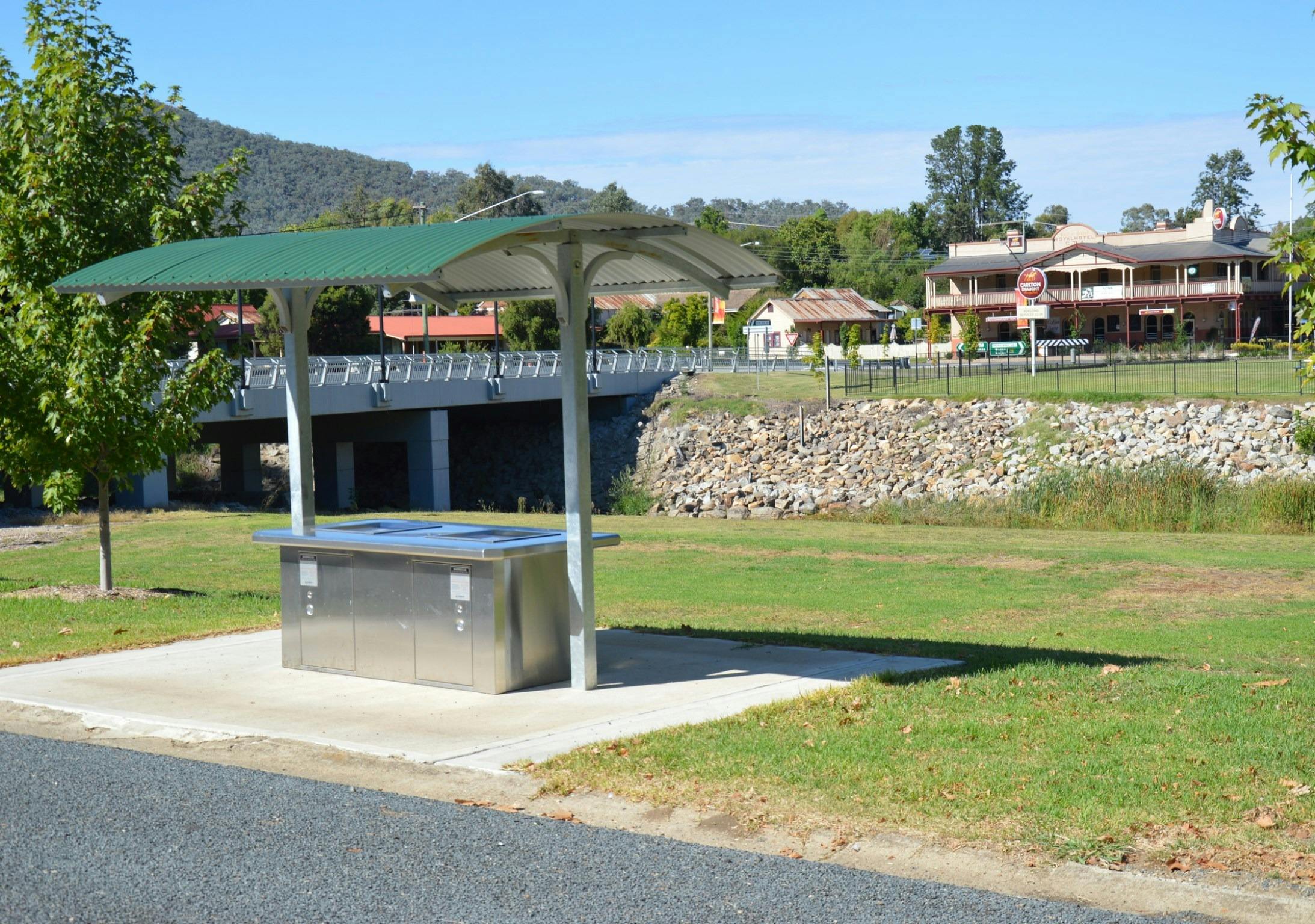 Barbeque area at Caravan park entrance, looking over creek towards the Royal Hotel