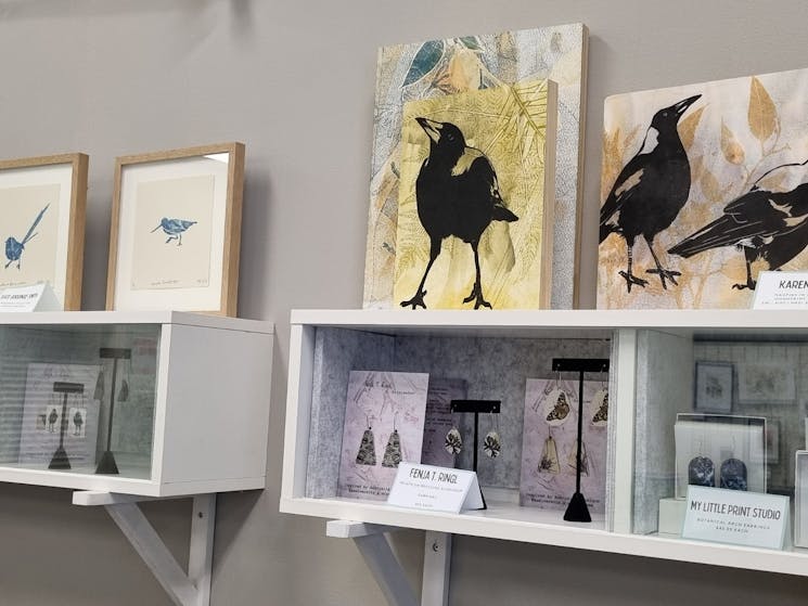 Wall shelf with magpie artworks and bird earrings