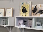 Wall shelf with magpie artworks and bird earrings