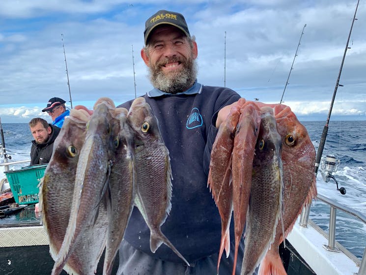 Man holding multiple catches