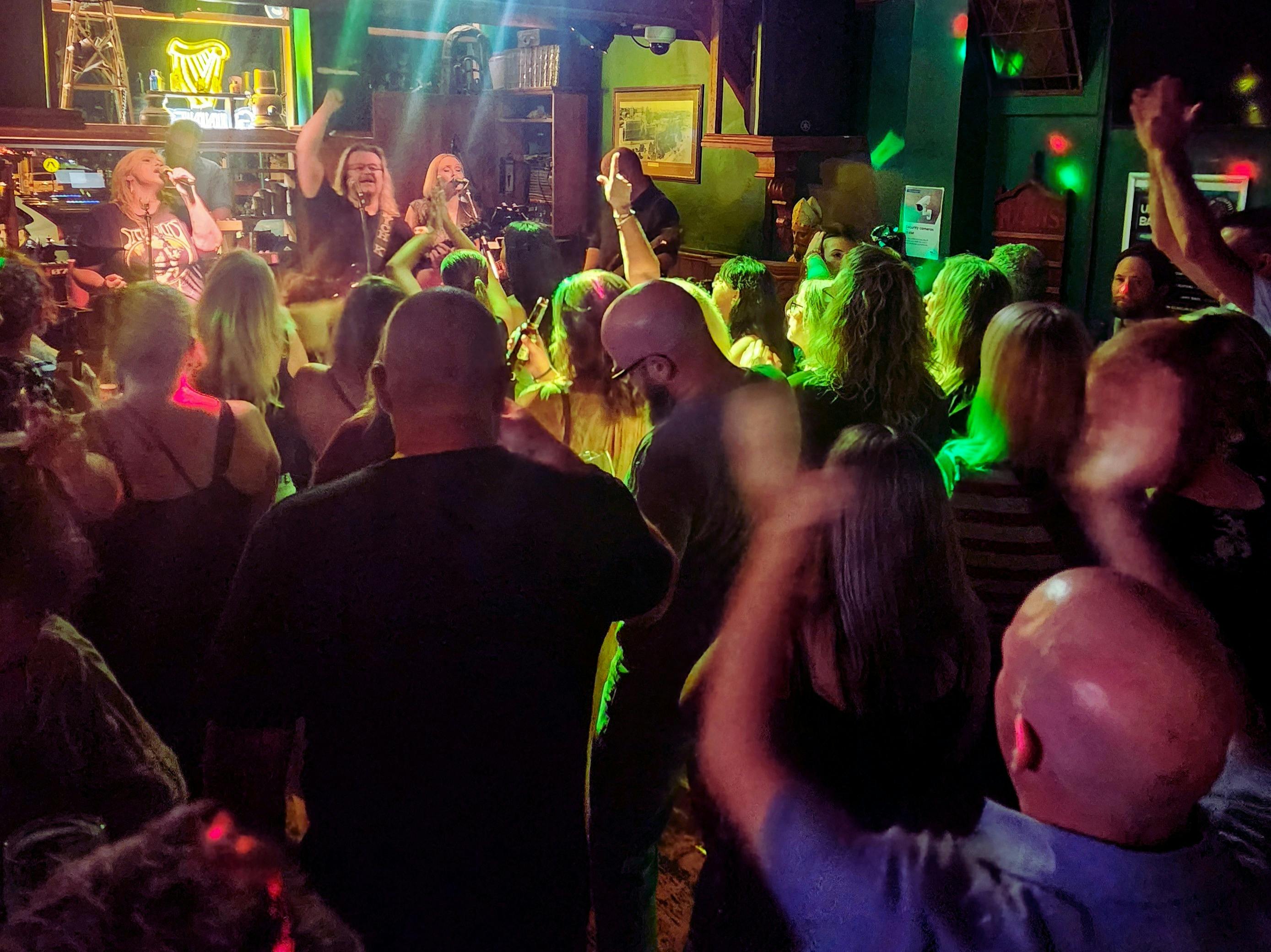 The crowd is dancing to the live music
