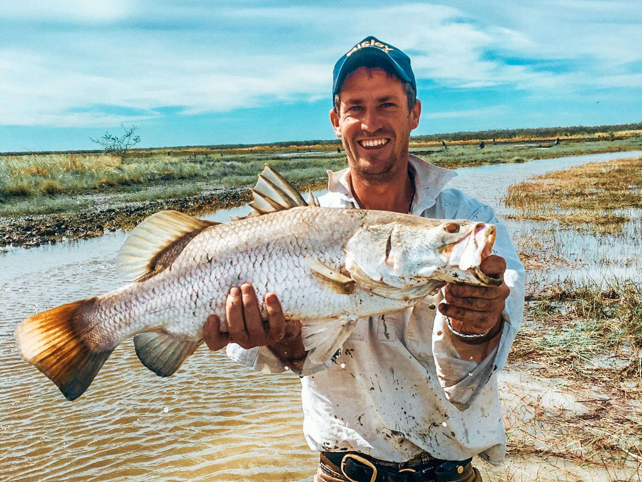 Landing a big barramundi straight from the floodplains. True Territory fishing at its best.