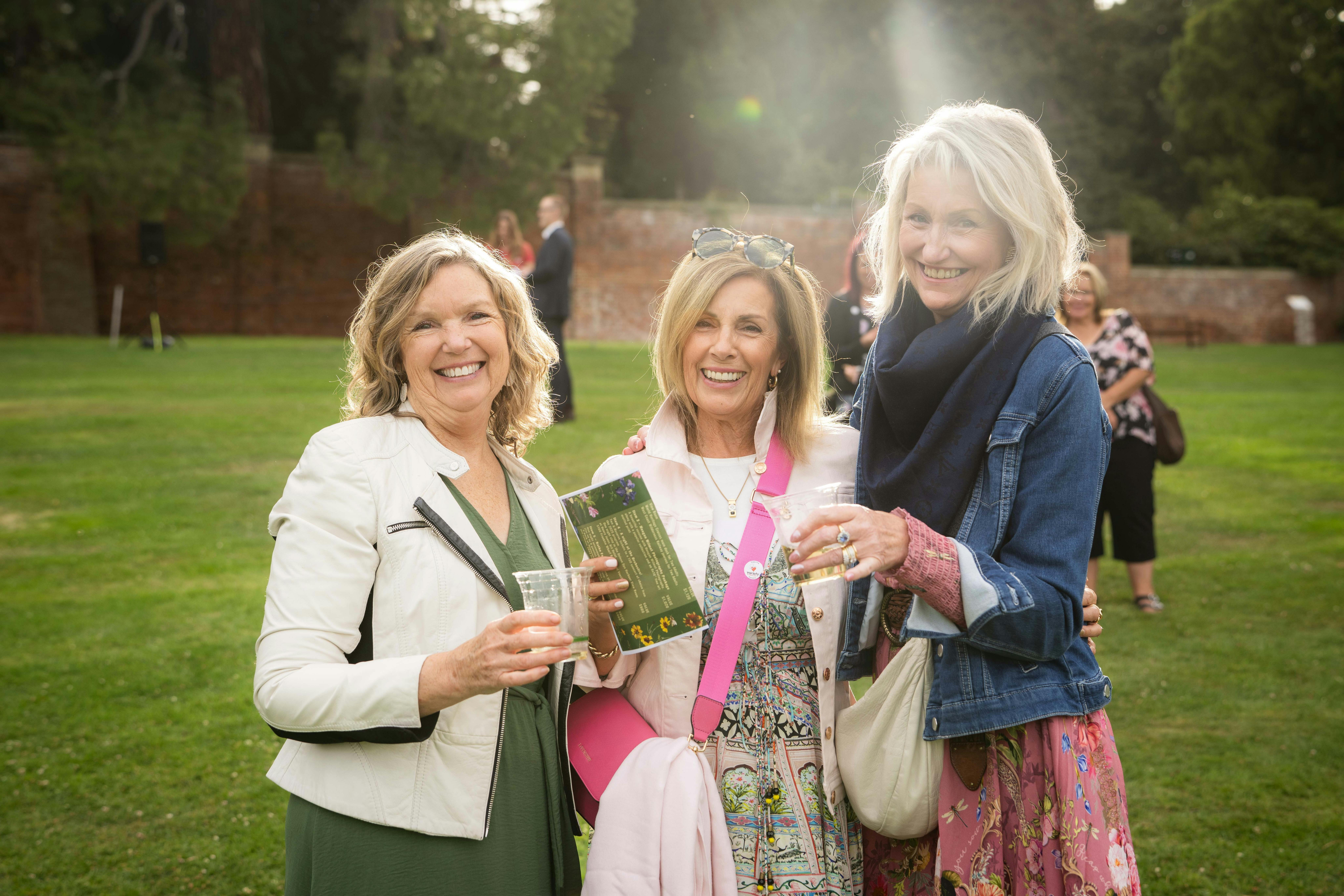 three women with cocktails in hand enjoying the late summer sun in the Botanical Gardens