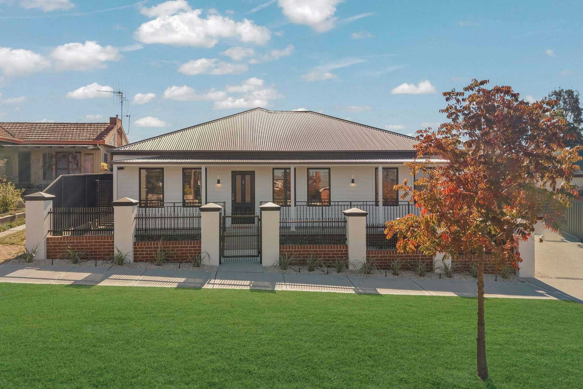 Exterior of property in Bathurst Black roof, grey paint and front fence