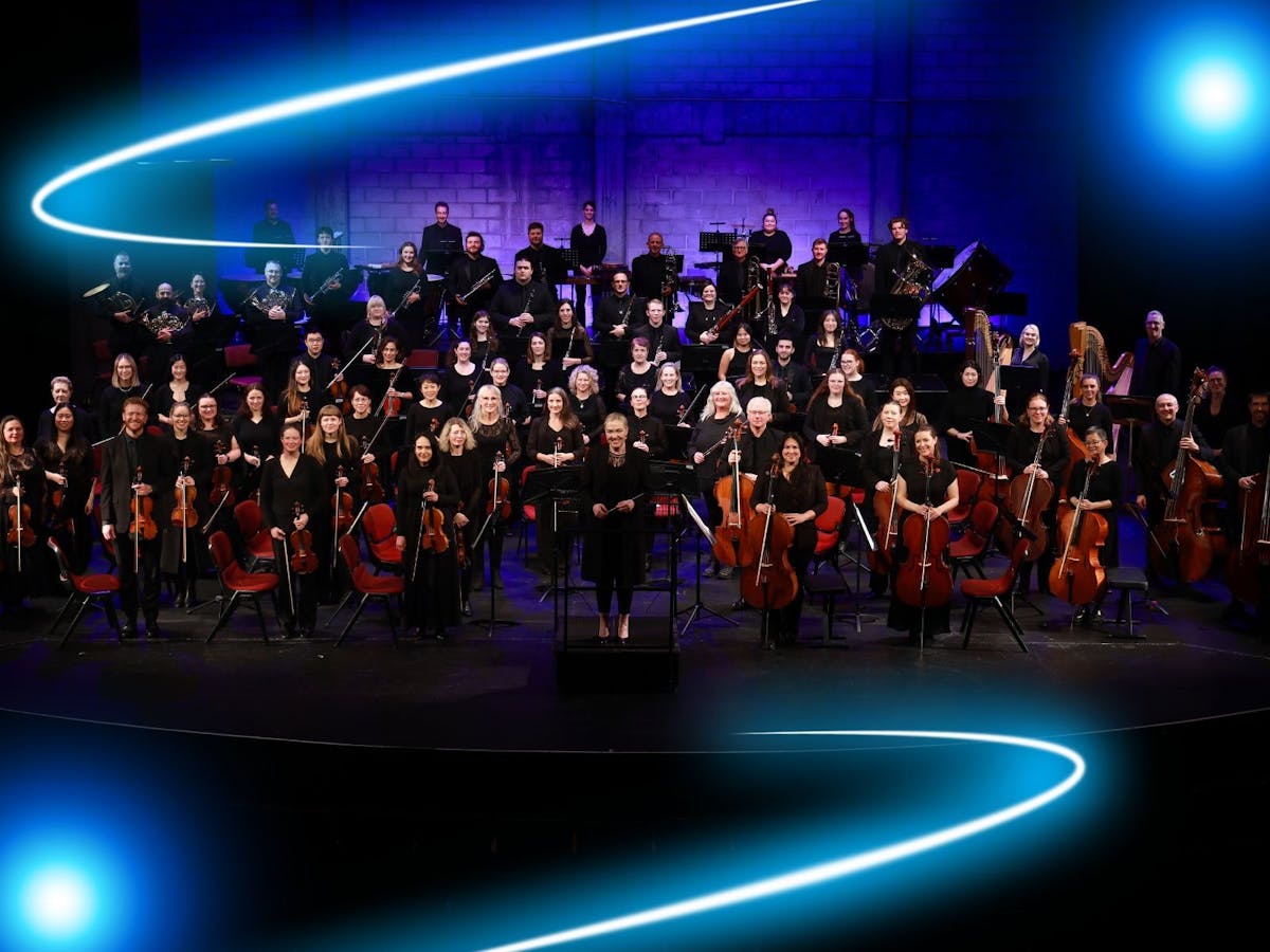 The Metropolitan Orchestra standing on a stage