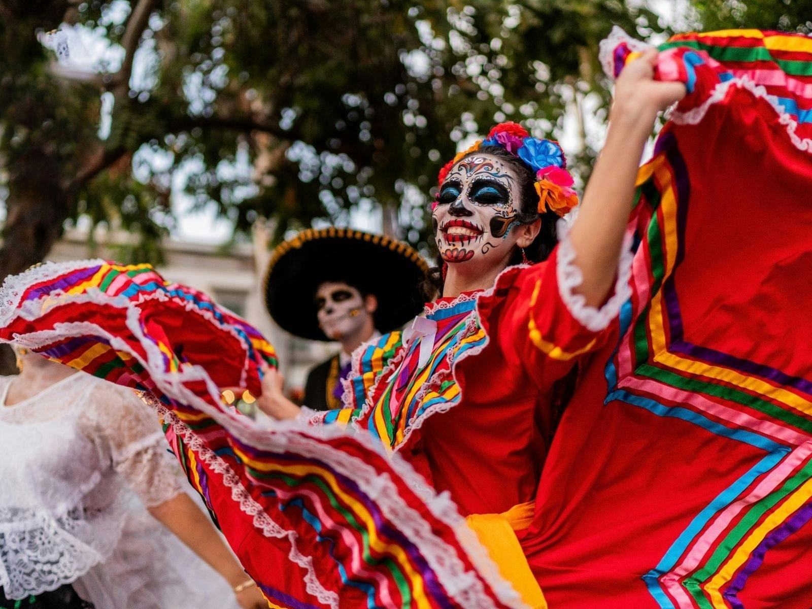 Woman dancing outdoors in day of the dead makeup