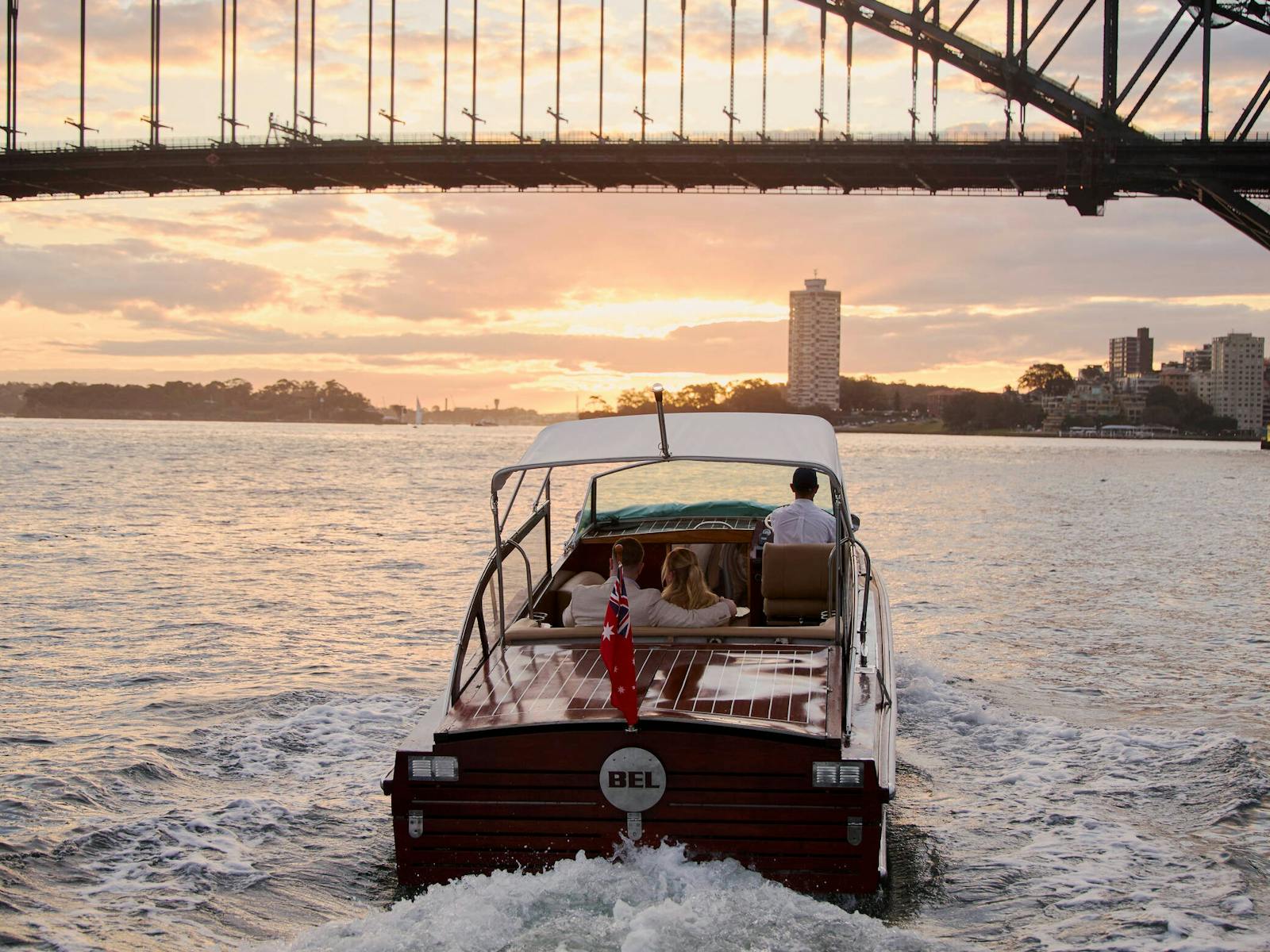 MV BEL private cruise on Sydney Harbour with Sydney city skyline and Harbour Bridge.