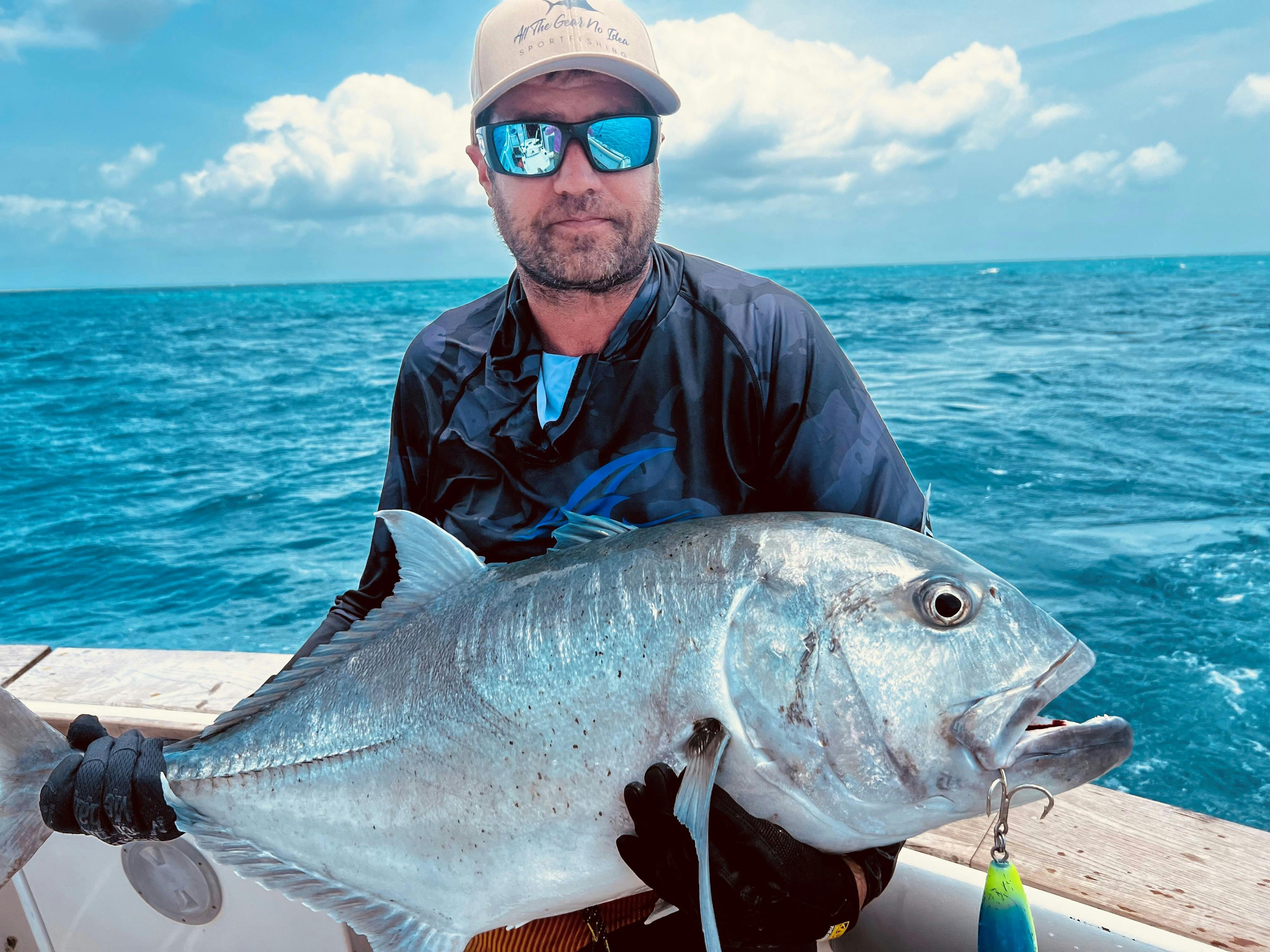 Charter guest holding big giant trevally