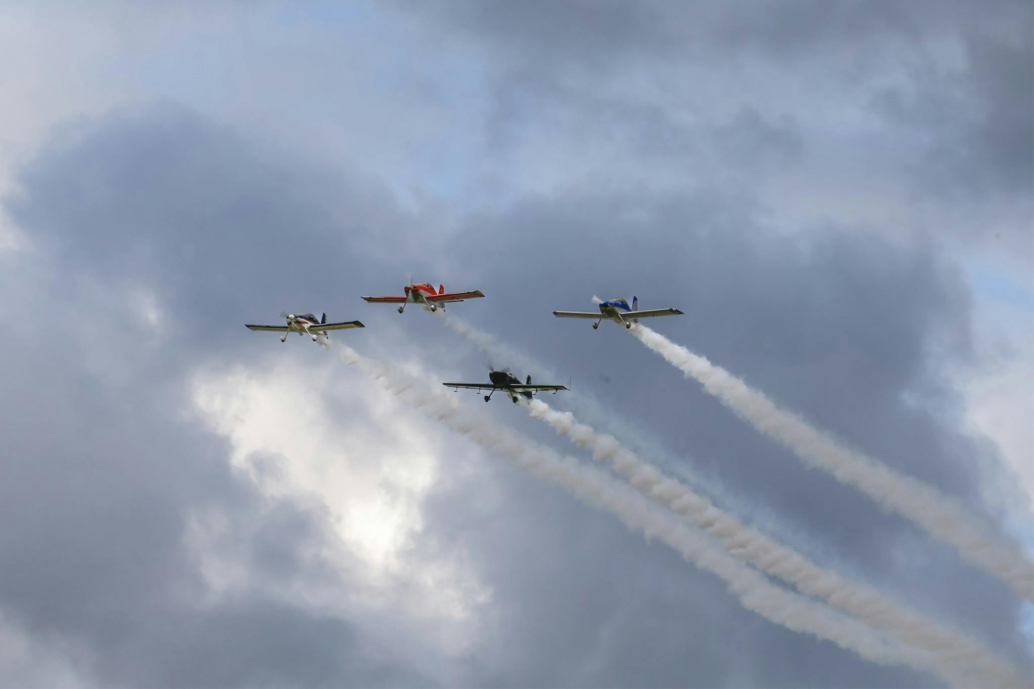 The silver sharks aerobatic team flying over The Bend at the OTR SuperSprint