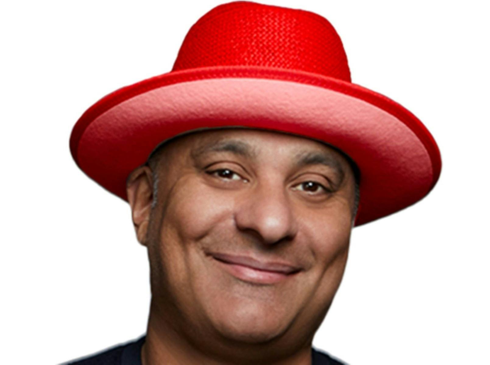 Photo of Russell wearing a red hat and a big toothless smile