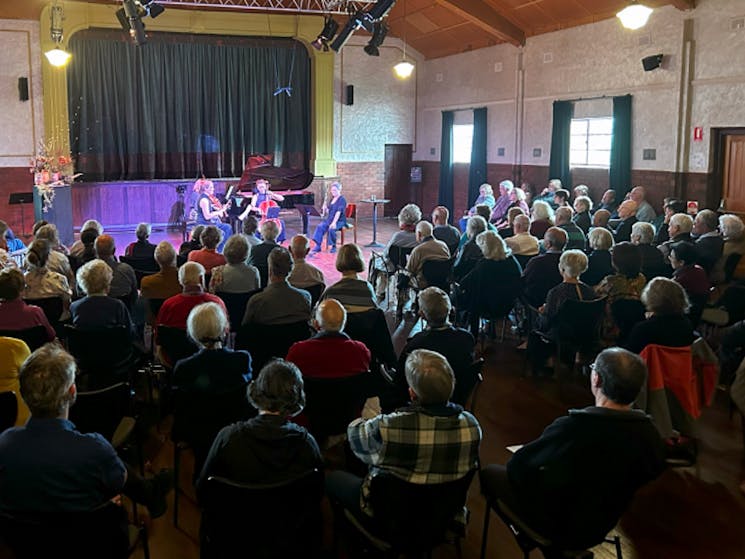 An audience watches musicians perform