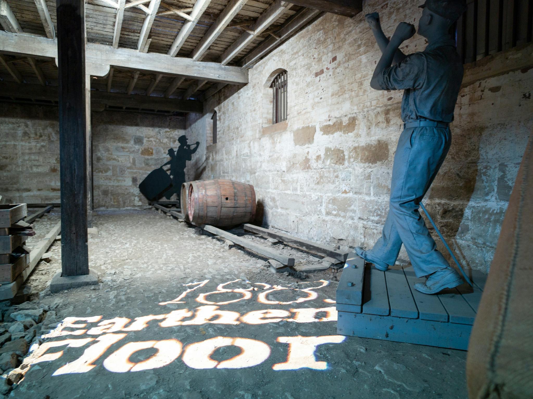 Photo inside Bond Store Museum depicting workers loading barrels in the basement. Photo inside Bond Store Museum depicting workers loading barrels in the basement.