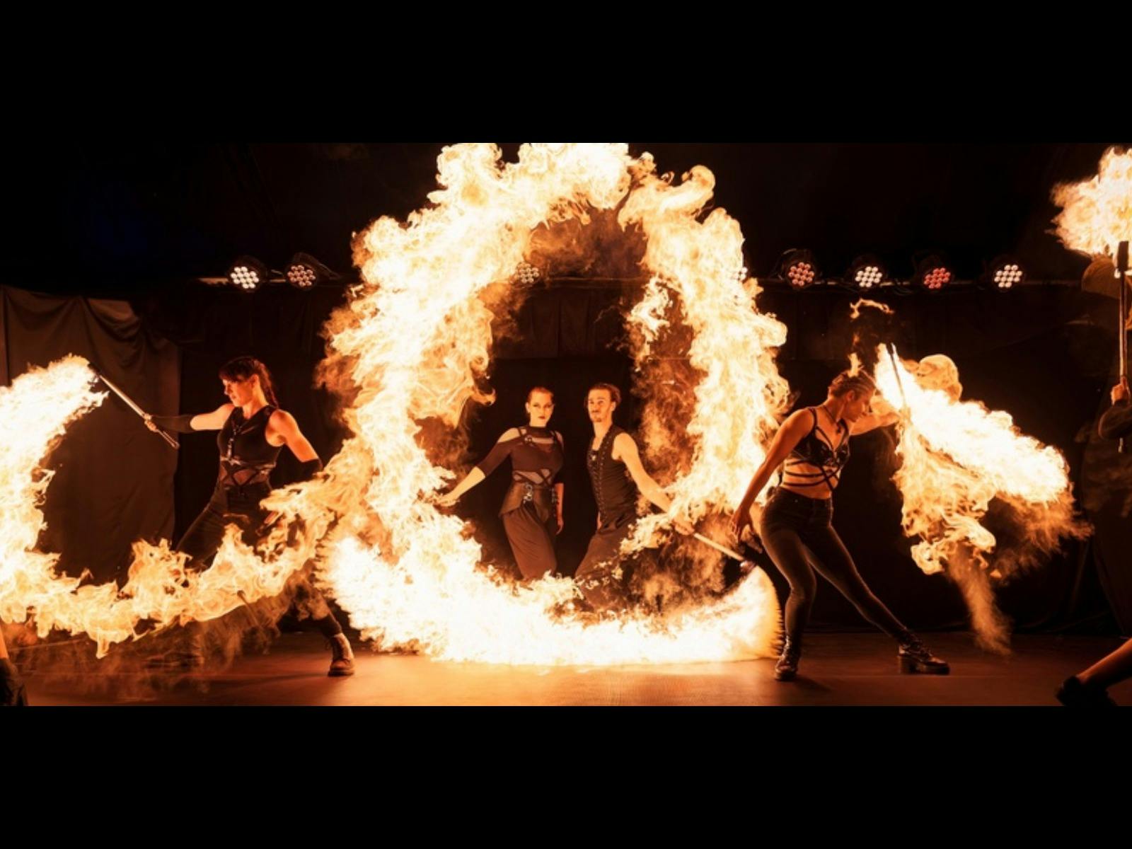 Performers surrounded by flames