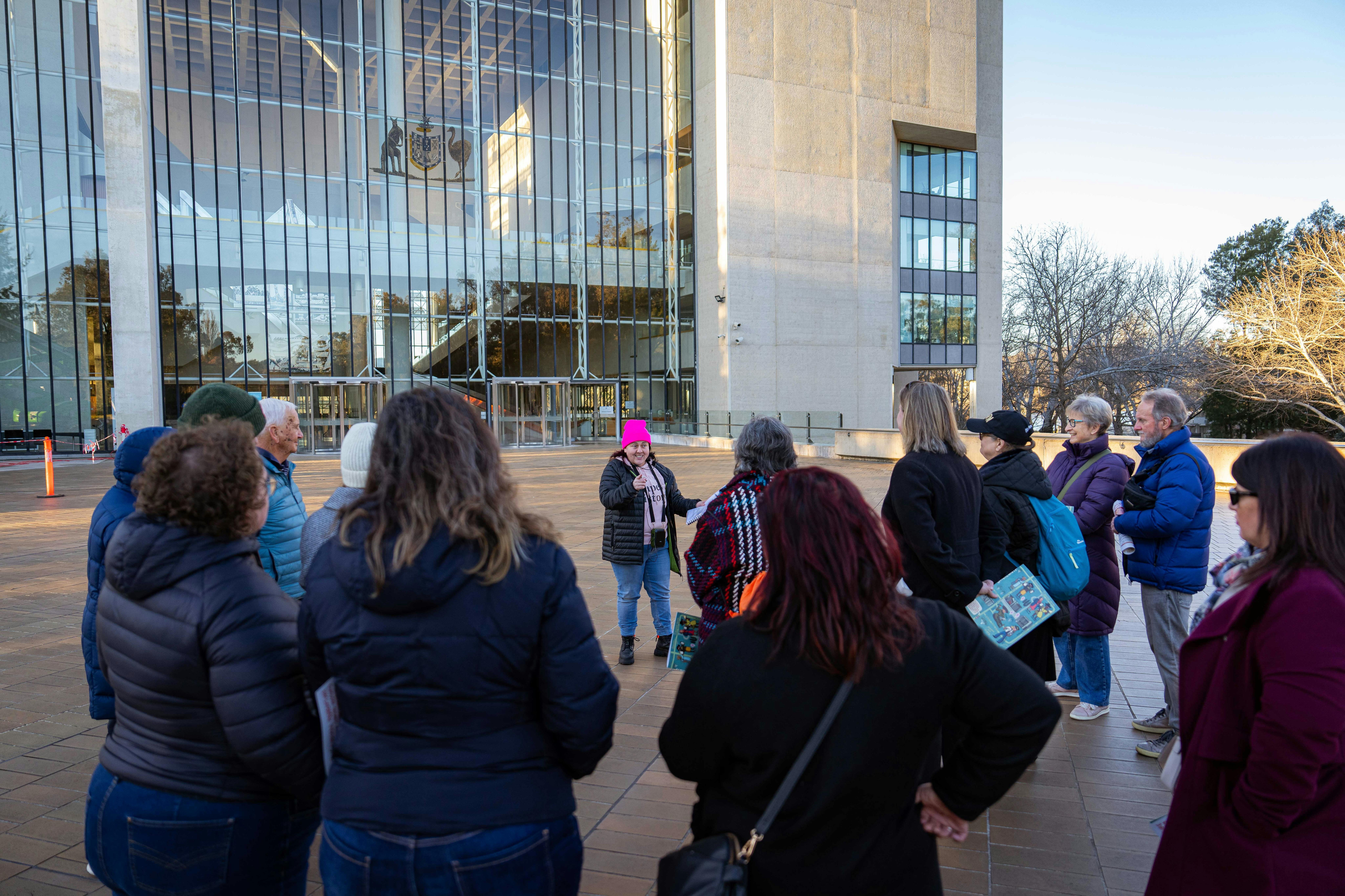 She Shapes History tour guide presenting to the group of engaged guests