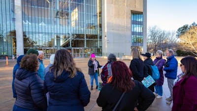She Shapes History tour guide presenting to the group of engaged guests