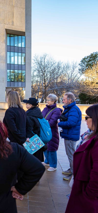 She Shapes History tour guide presenting to the group of engaged guests
