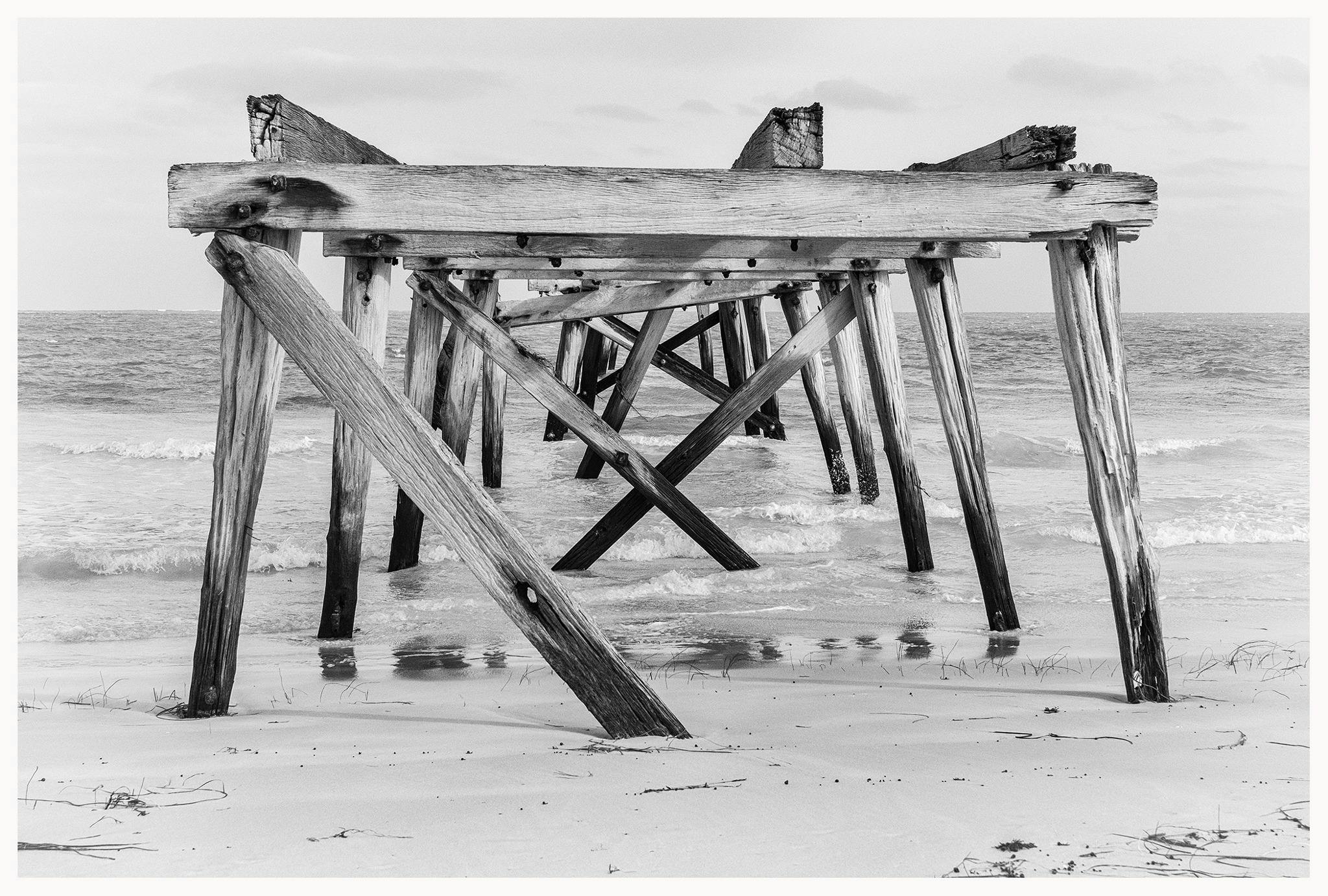Black and white arty photo of jetty ruins