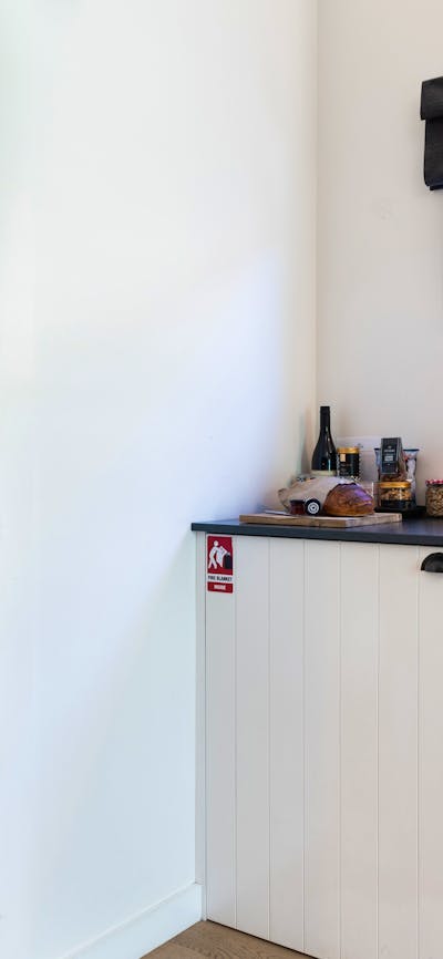 Kitchenette to the right and an open door to the left showing a cosy bunk bed room