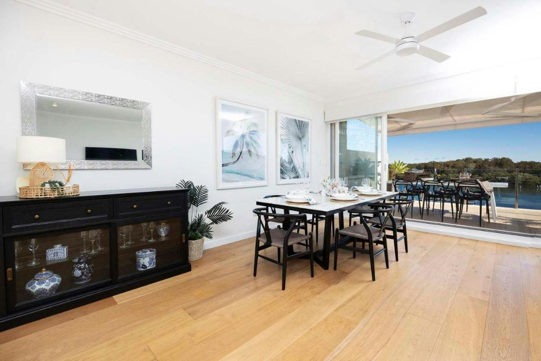 Dining area with ceiling fan and lake views
