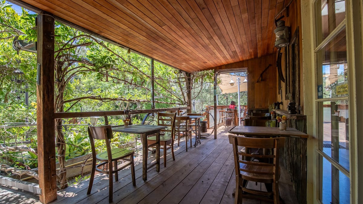 outdoor seating amongst green gardens and rustic decor