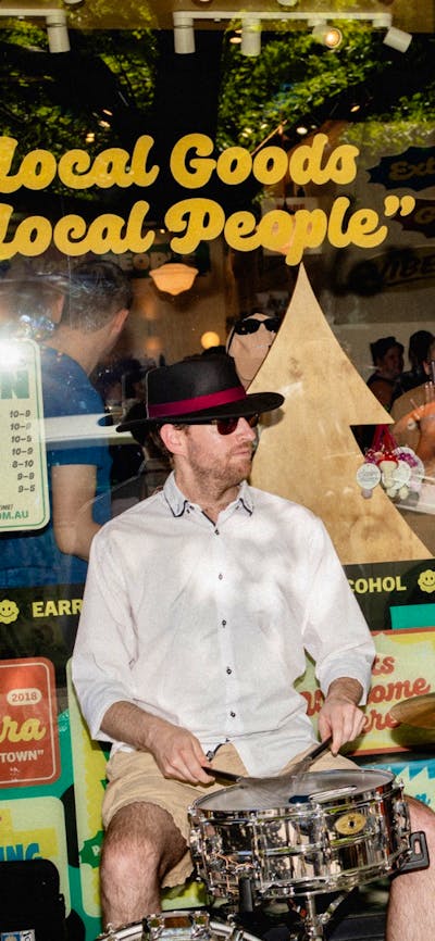 A jazz trio performing outside POP Canberra, entertaining shoppers at community events.