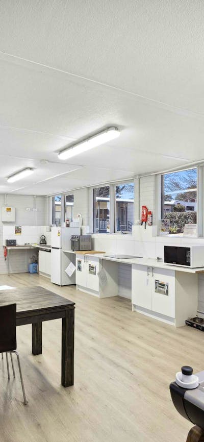 Spacious guest rec room with dining, cooking facilities & air hockey for guests to enjoy