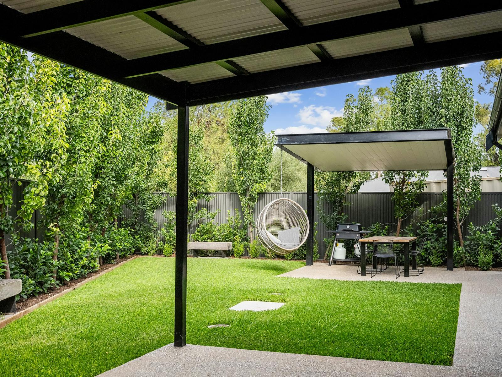 Backyard with outdoor dining BBQ and hanging chair