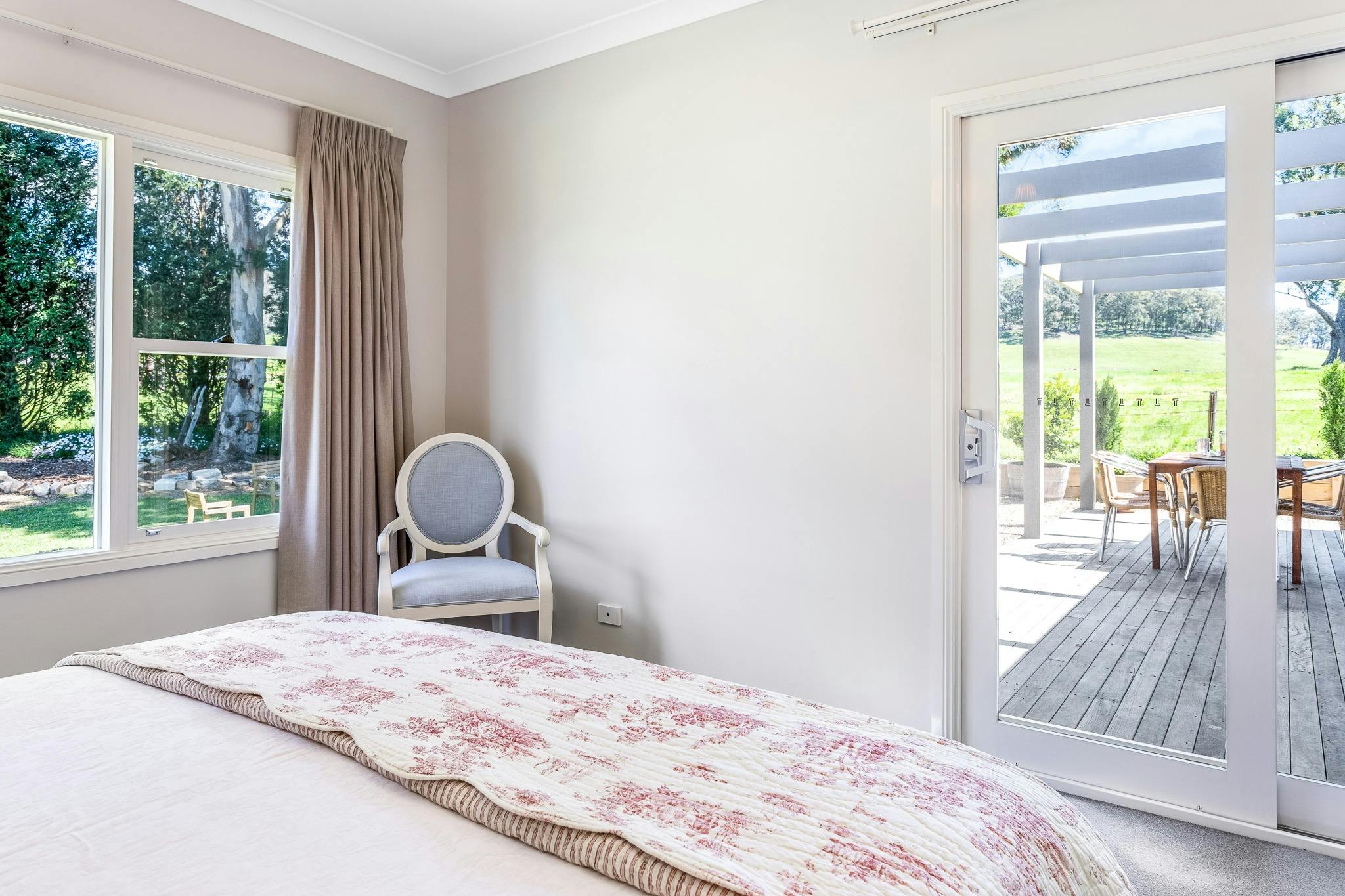 King bedroom overlooking covered outdoor deck