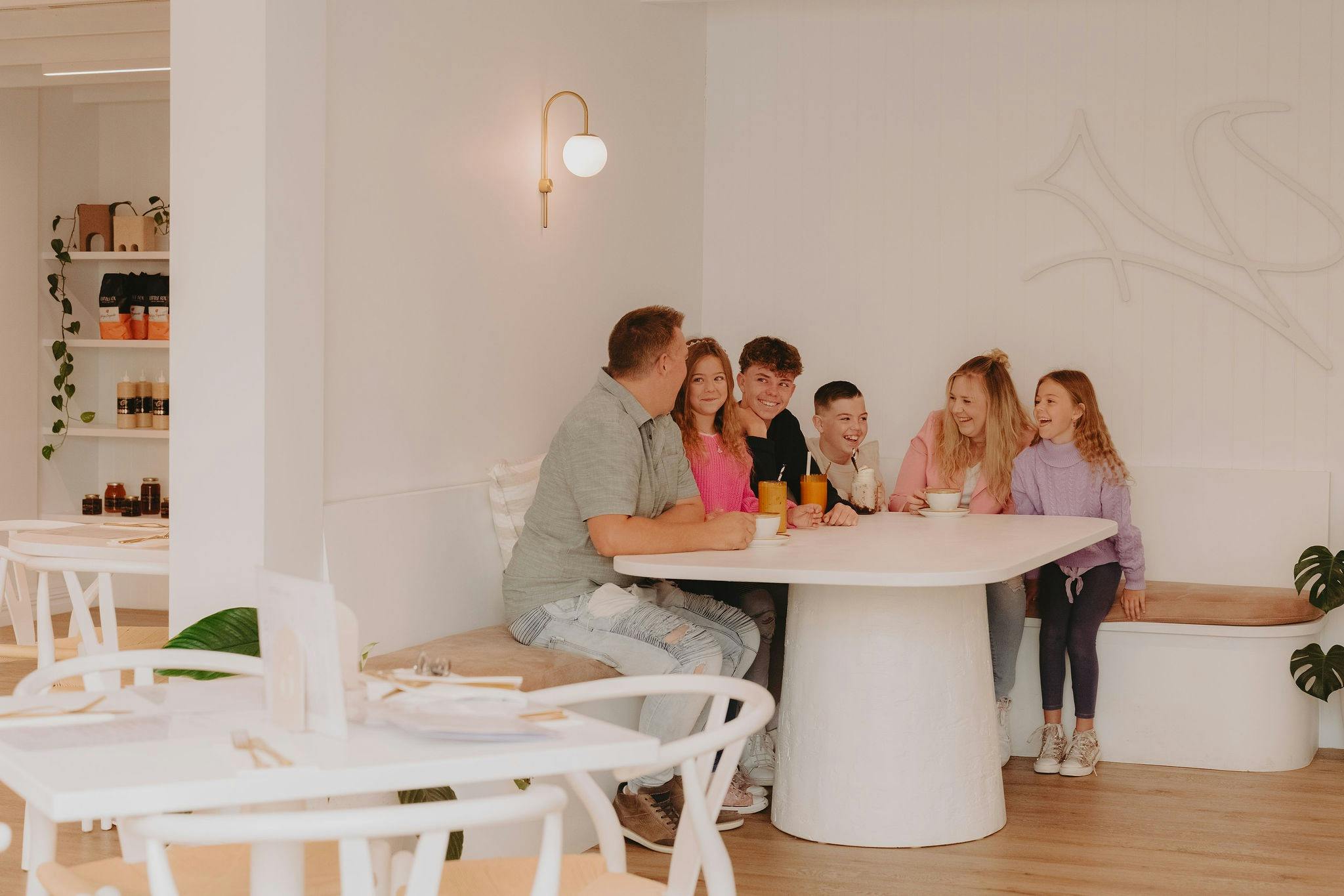 Family sitting on the corner of the Fox and Brew Cafe