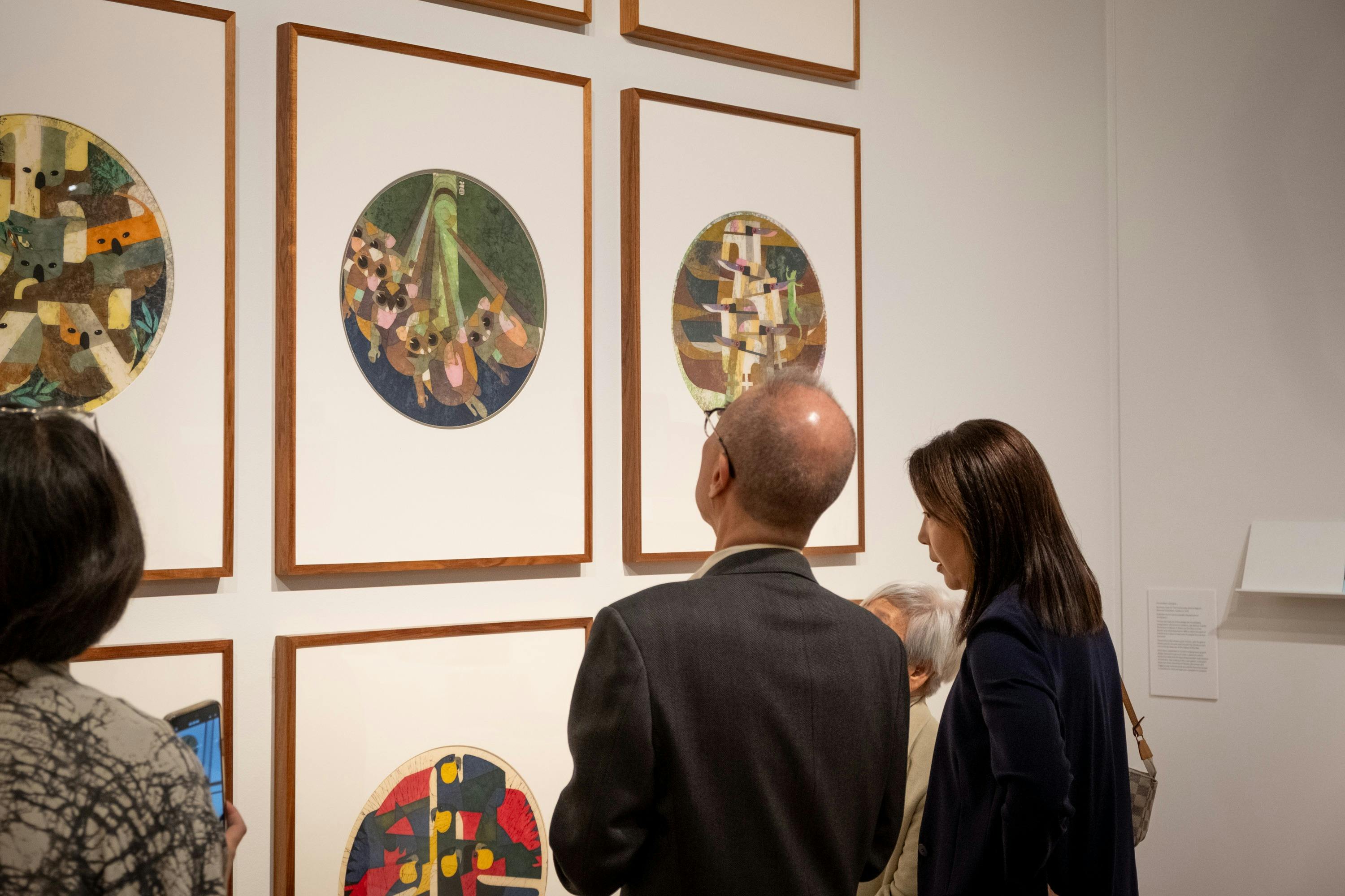A couple examine the batik works of Cornel Swen