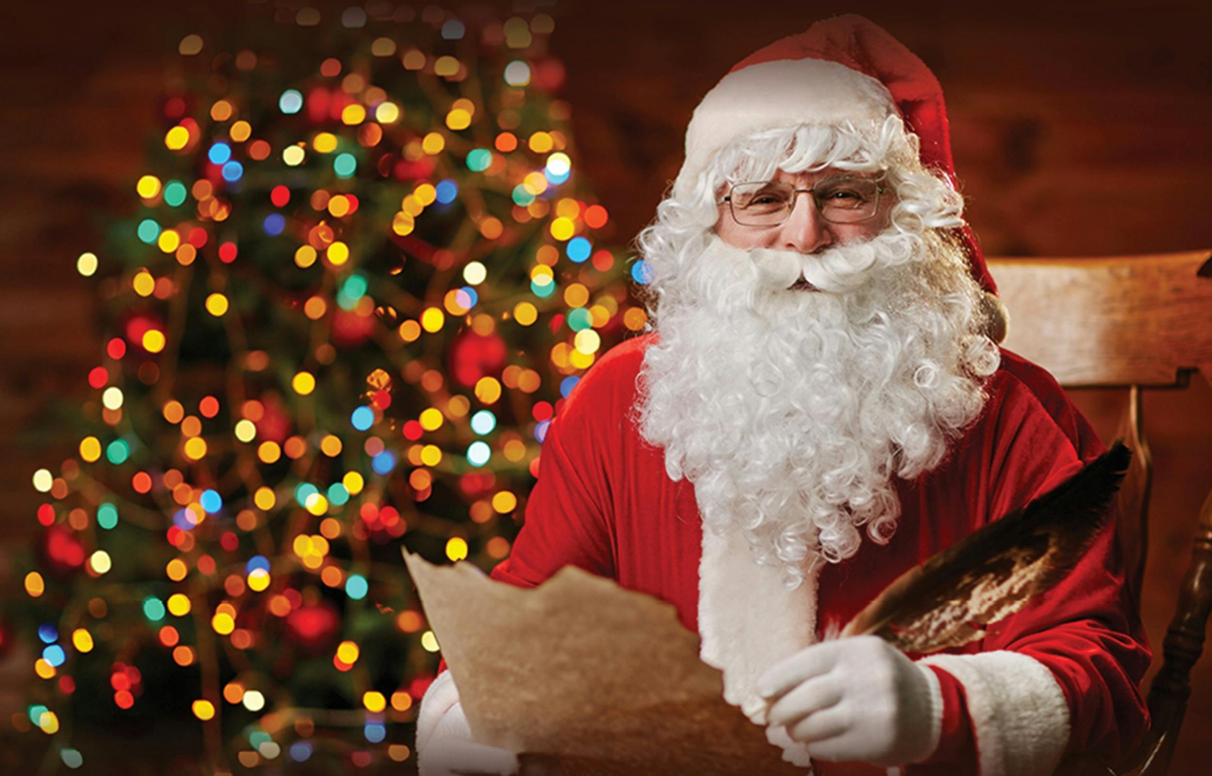 Image of Santa with a Christmas tree in the background