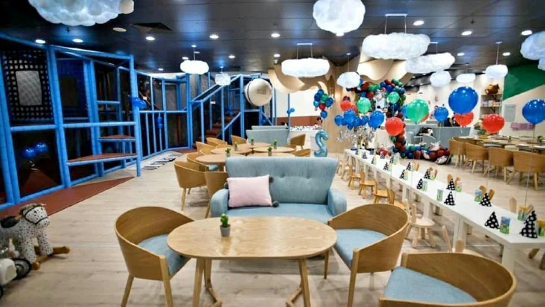 Tables and chairs and a long trestle set up for a party and cafe seating