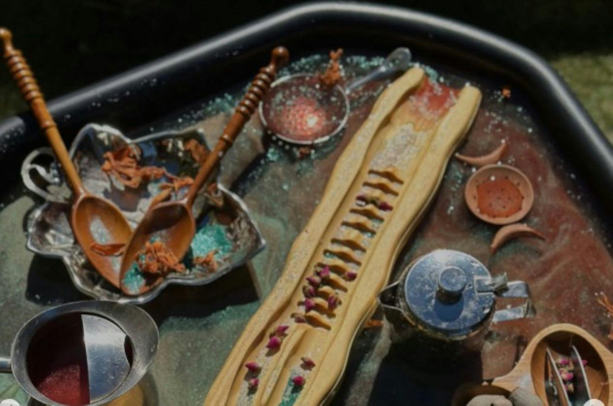 scoops, teapots, glitter, water and ramp in play tray