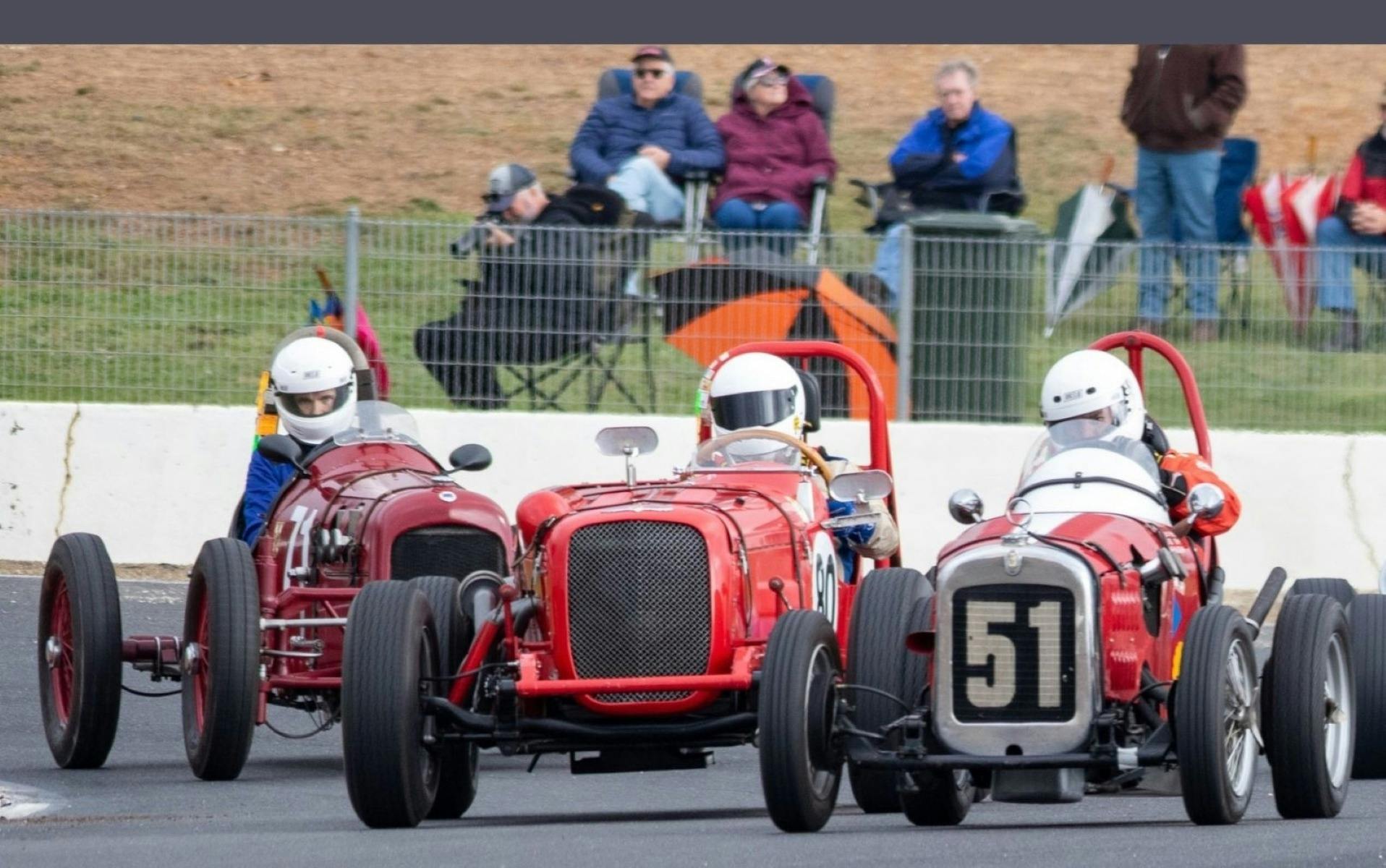 Races cars from 1920s competing on track