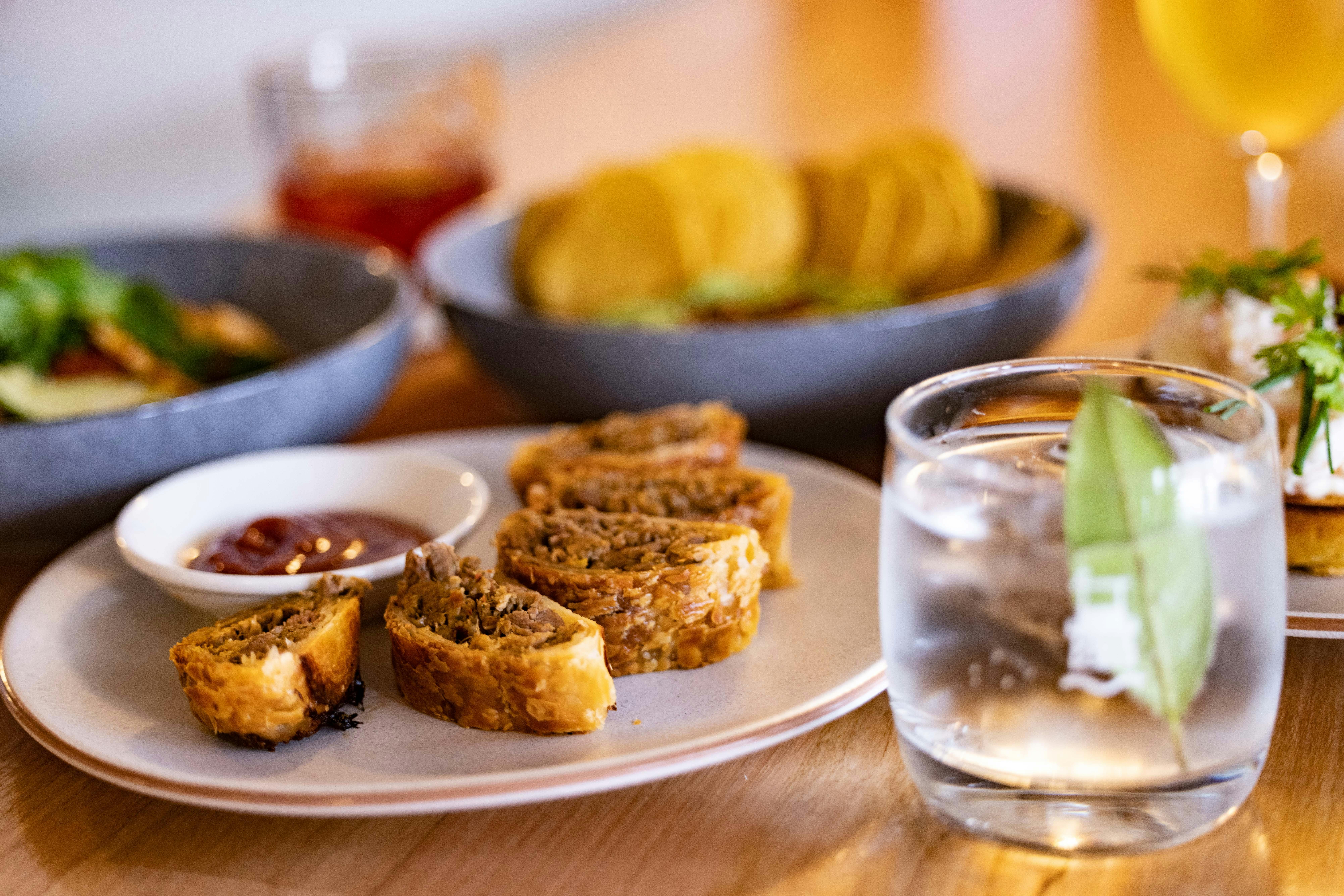 pulled lamb and harissa sausage rolls with gin ketchup
