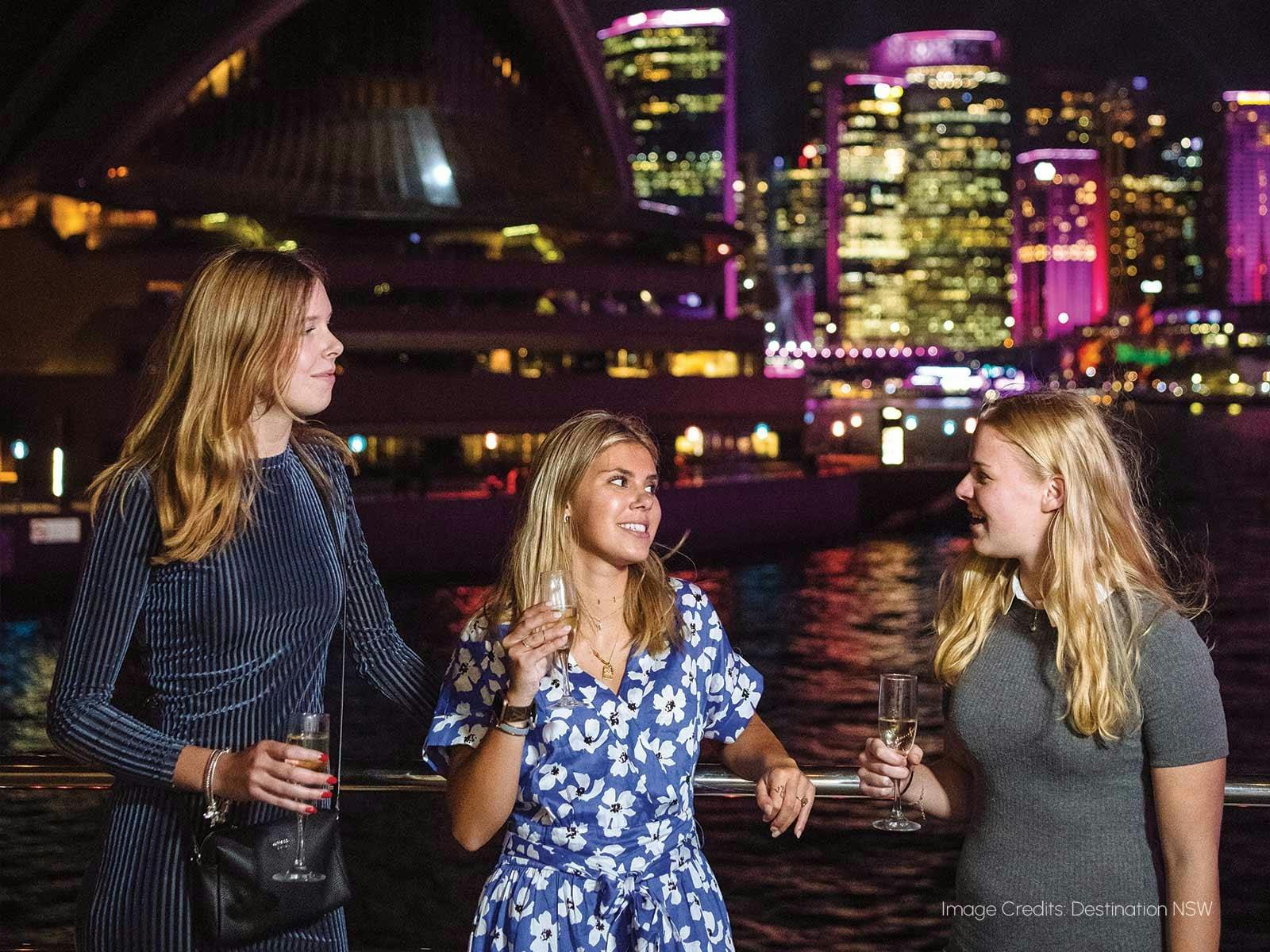 Guests enjoying a drink aboard the Magistic Vivid Sydney cruise