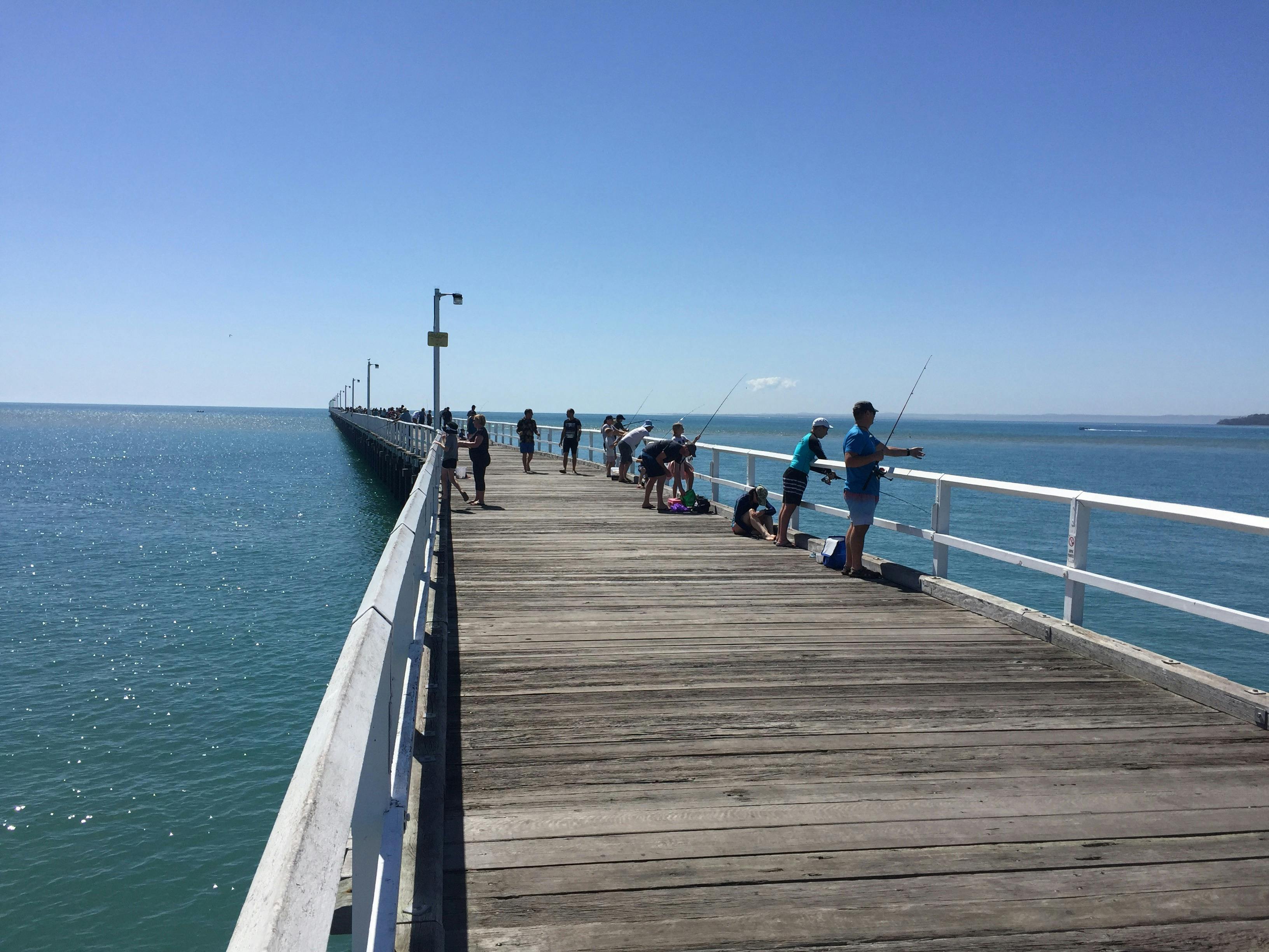 photo showing people fishing off Urangan Pier Hervey Bay
