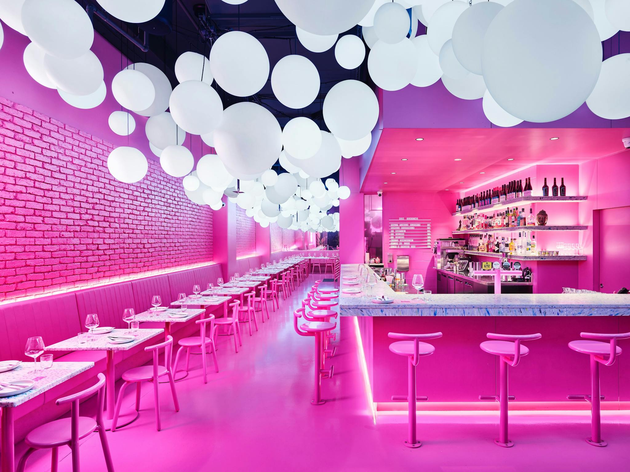 PingPong's vibrant pink main dining room which features a room drenched in bright pink hue PingPong's vibrant pink main dining room which features a room drenched in bright pink hue