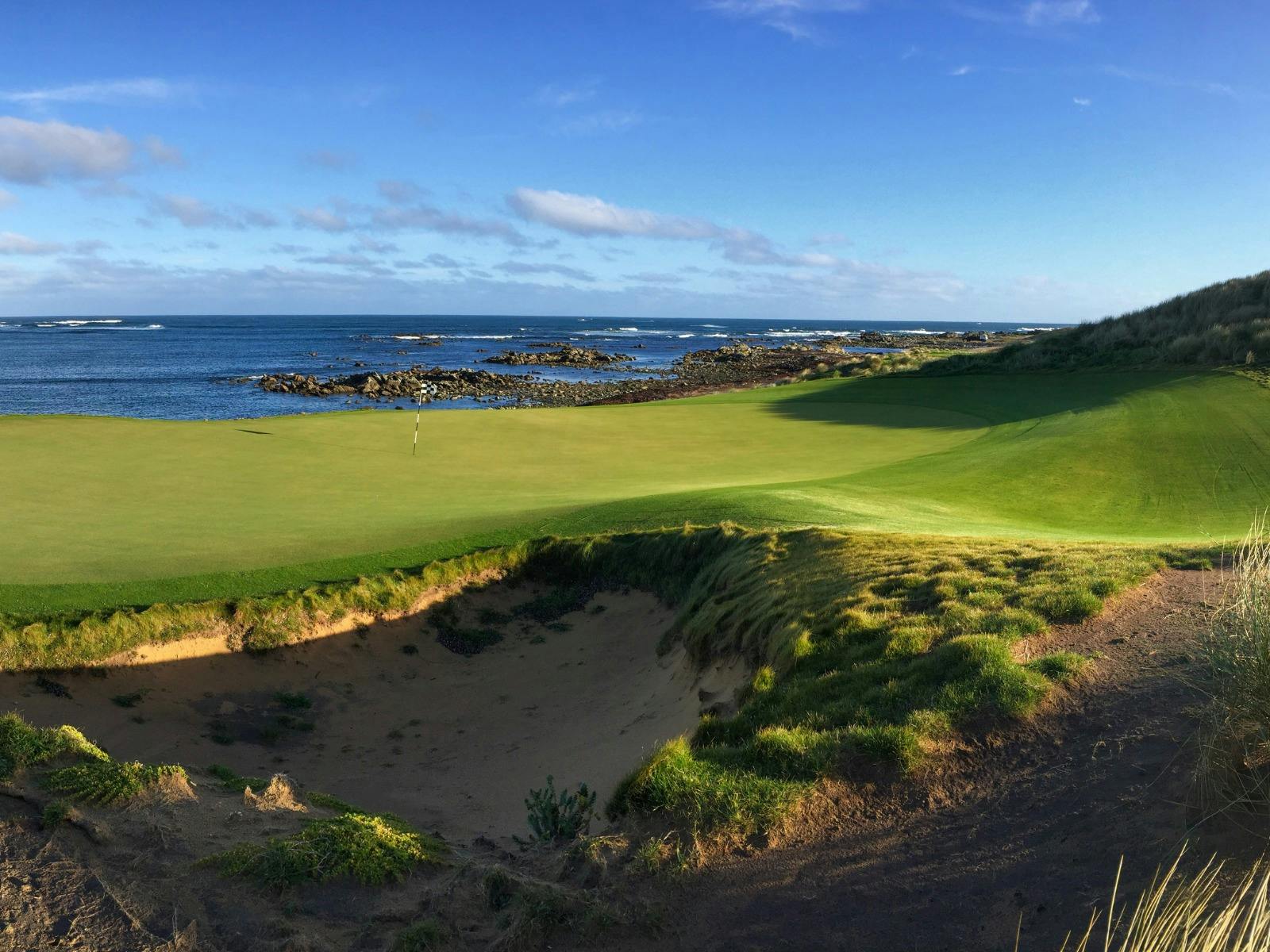 10th hole at Ocean Dunes Golf Course with coastal views, ocean backdrop, and dramatic green.