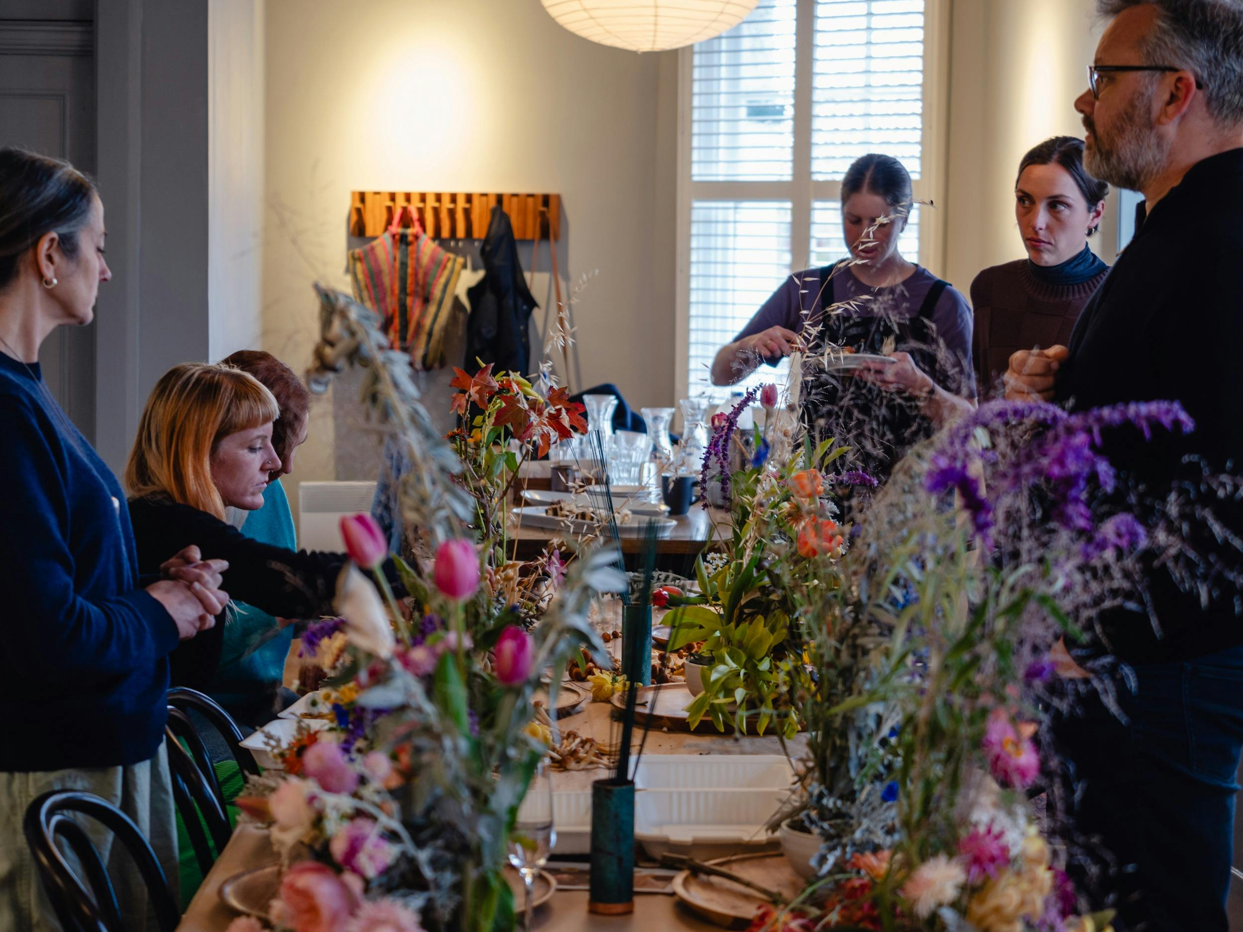 A group of people in a fungi and floral workshop