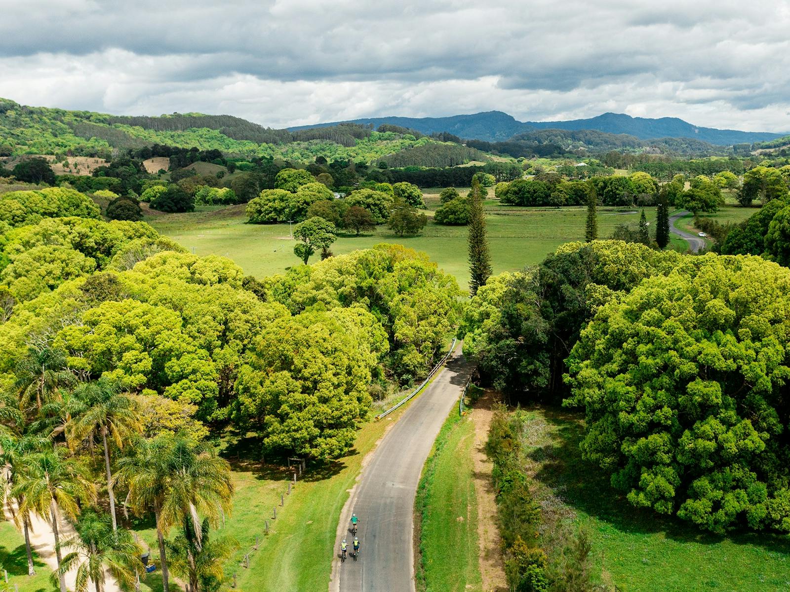 Drone shot showing group of riders on an ebike tour and the lush hinterland of The Pocket