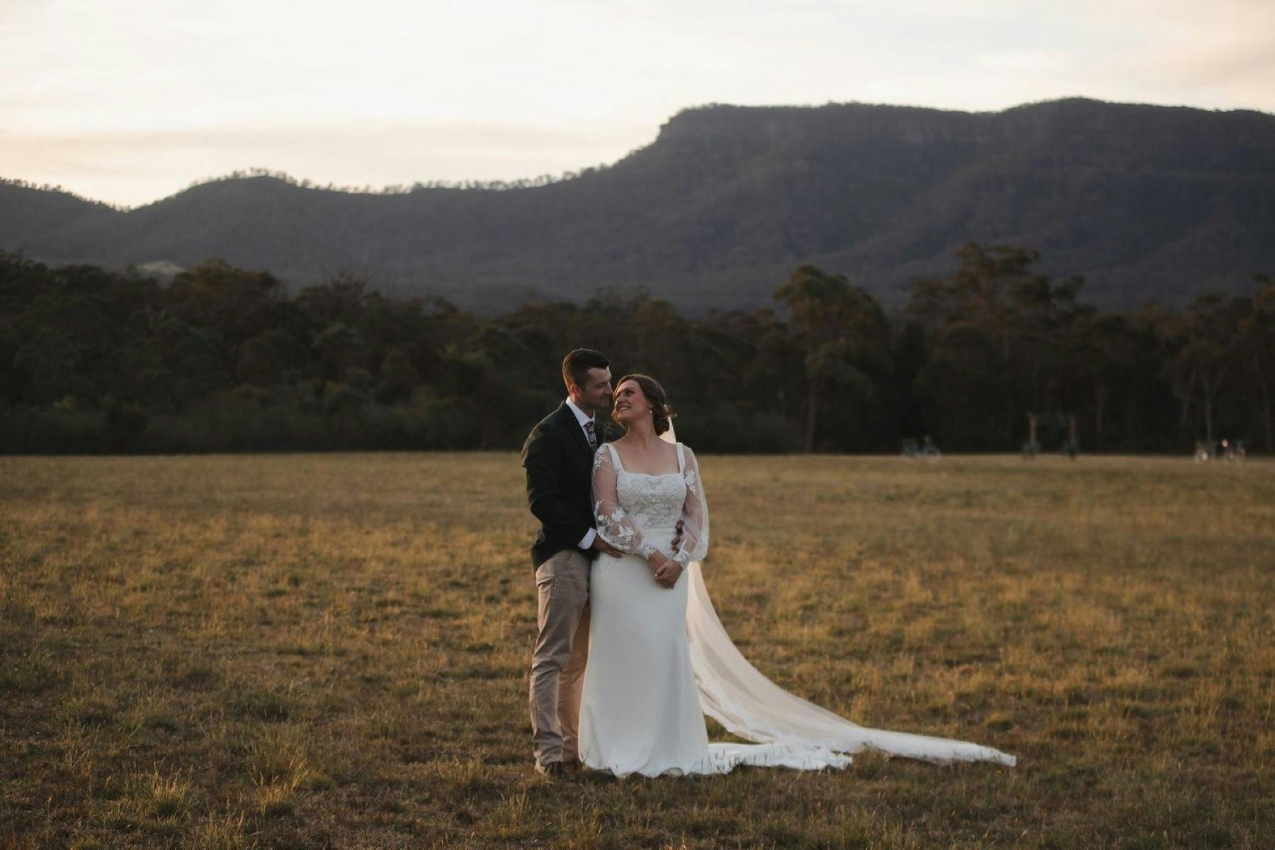 Image of a couple on there wedding day. Kangaroo Valley mountain view in background.