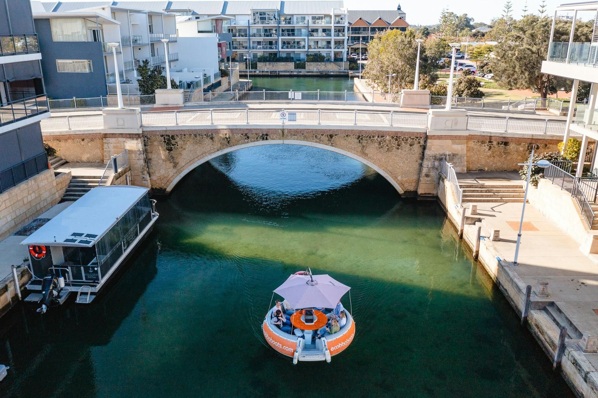 BBQ boat going under bridge in Mandurah Venetian Canals