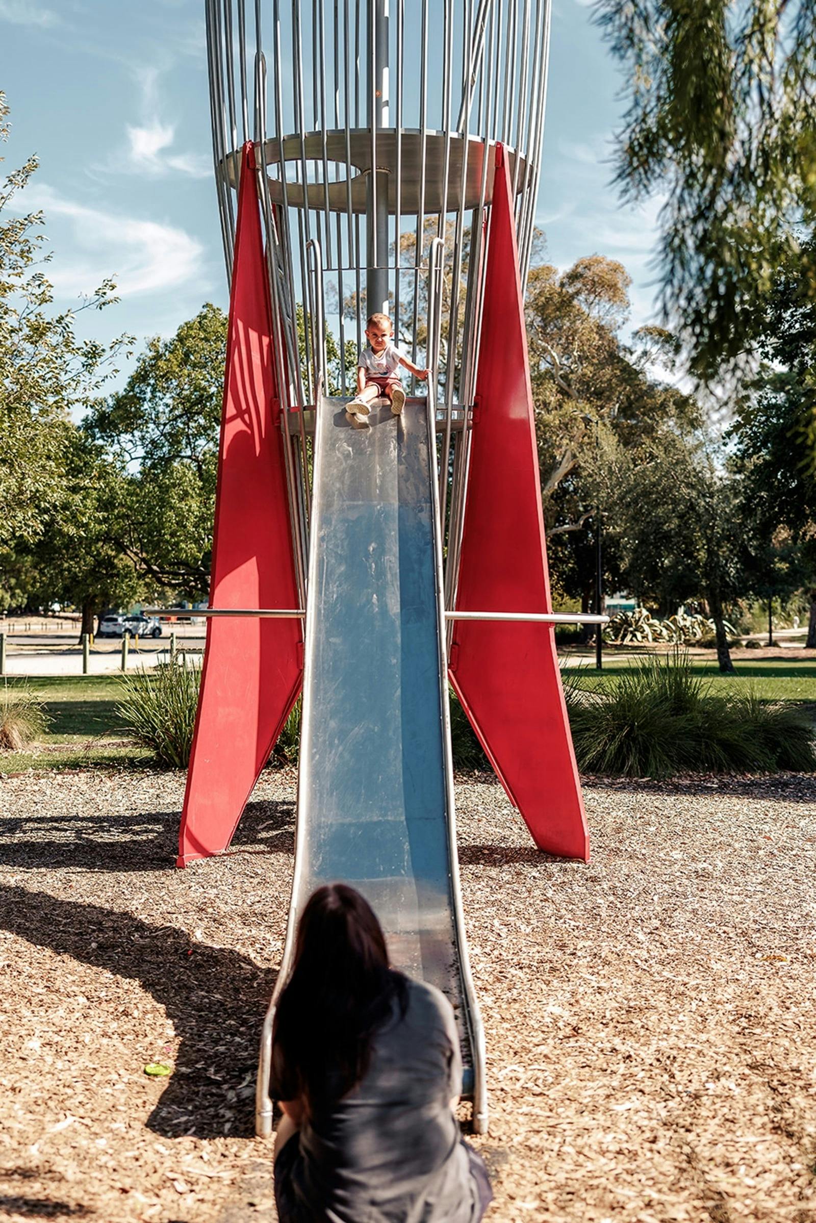 A child ready to slide down the rocket ship at the Benalla Adventure Playground