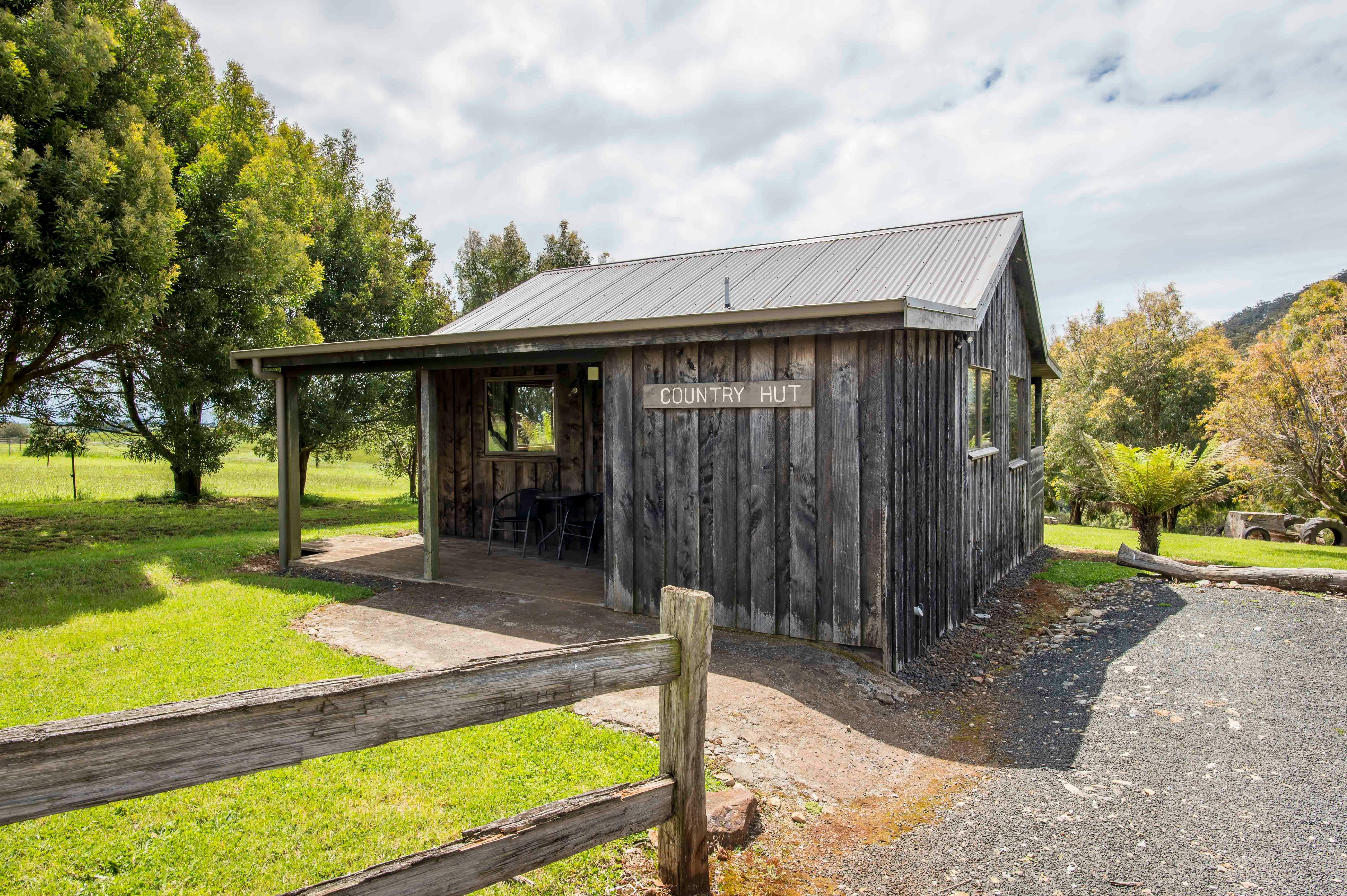 Country Hut Exterior with paved entrance into hut no steps