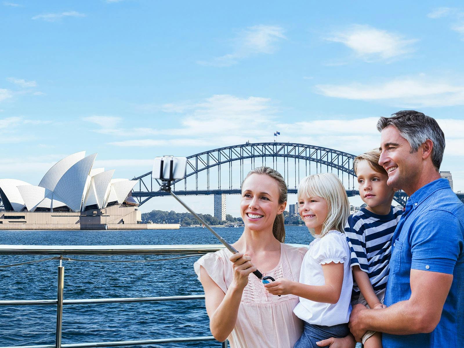 Family captures a photo against the iconic harbour aboard a lunch cruise