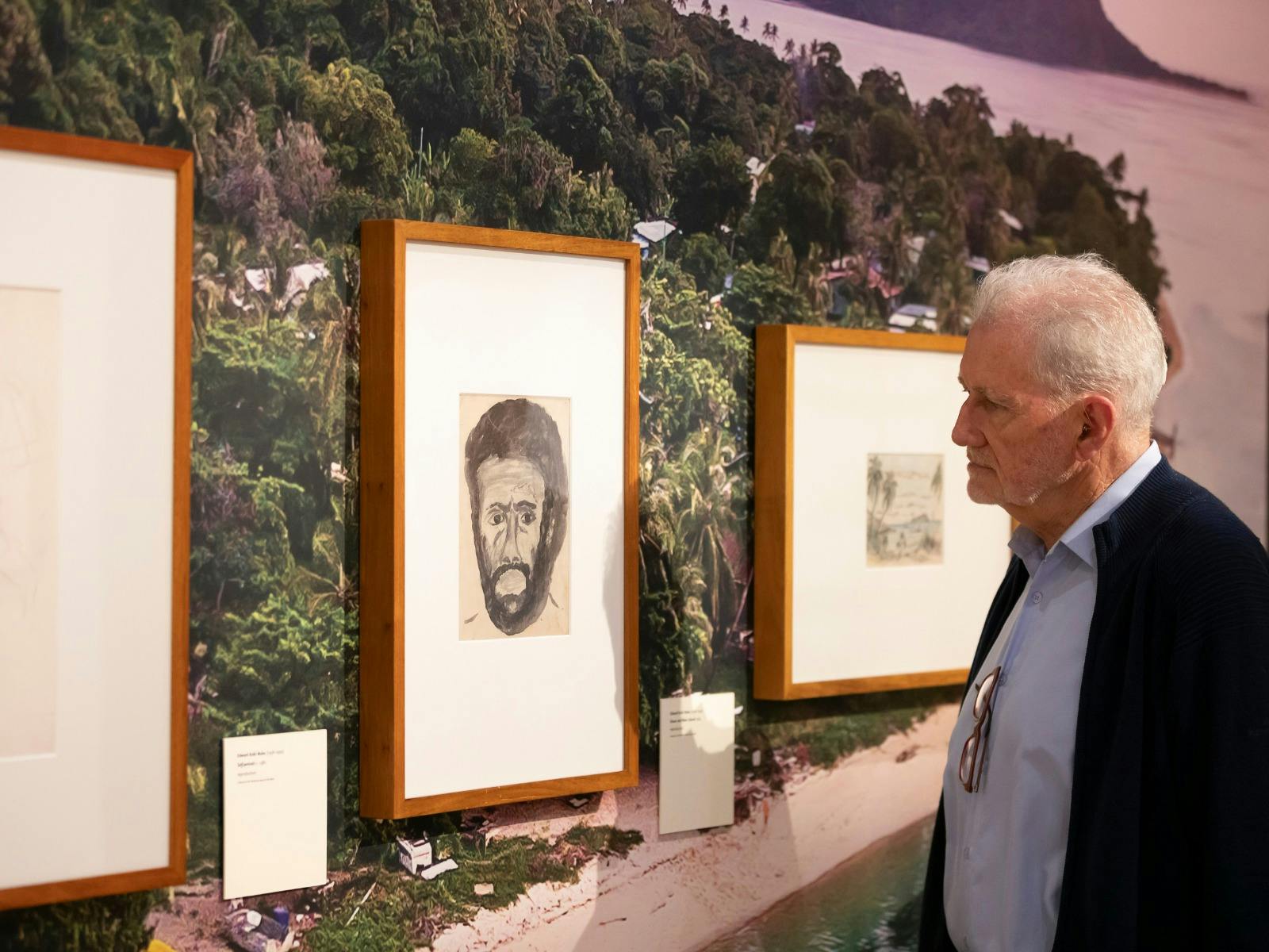 A gentleman viewing a collection piece in a gallery