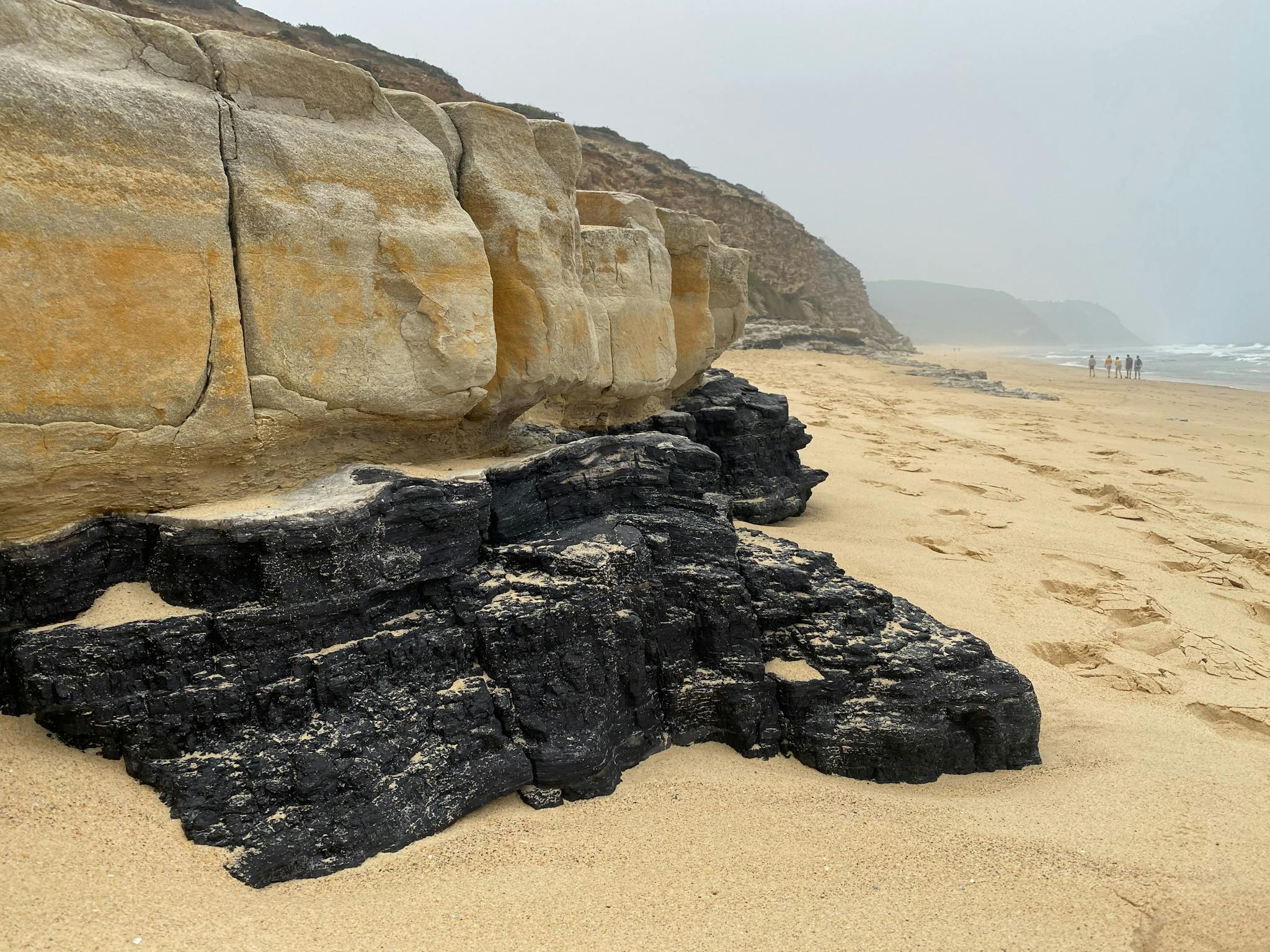 Rocks and coal exposed on a beach