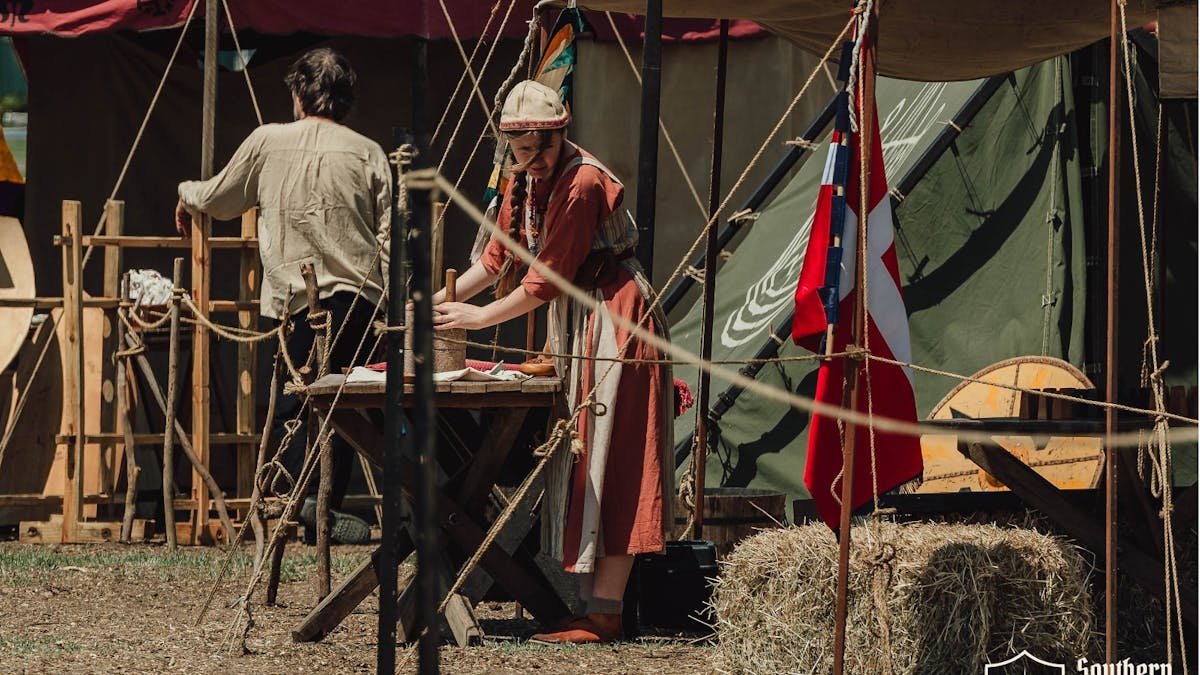 Historical reenactor working outside a Viking tent at Southern Realm Festival.