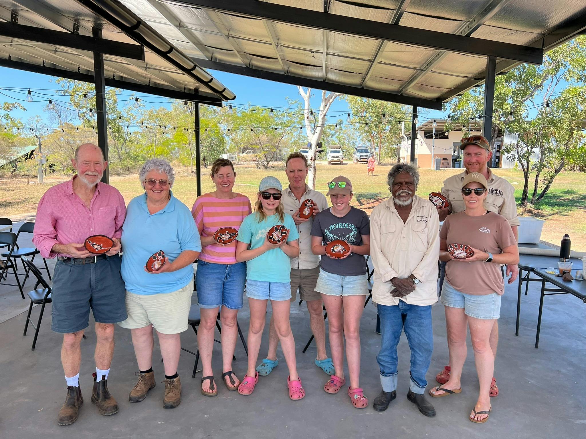 Tourist show off their paintings